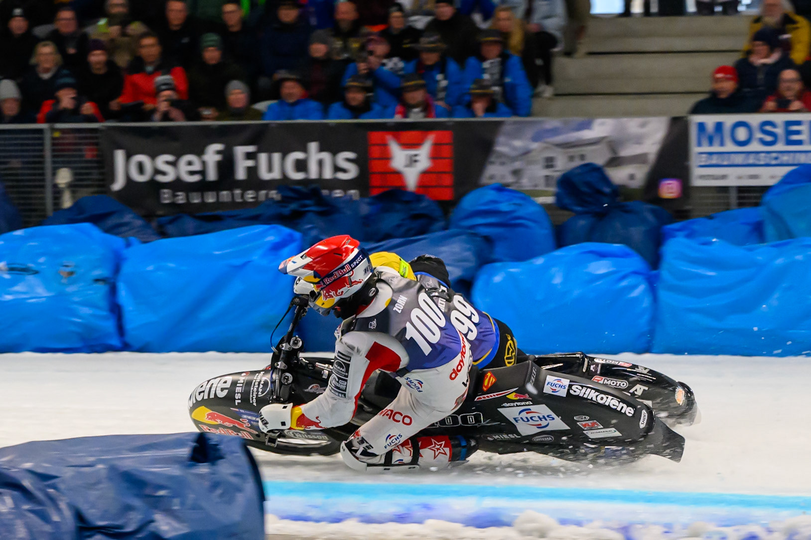 Franz Zorn (100) of Austria in Red rides inside Martin Haarahiltunen (199) of Sweden in Yellow behind during the Ice Speedway Gladiators World Championship Final 2 at Max-Aicher-Arena, Inzell on Sunday 15th March 2026. (Photo: Ian Charles | MI News)