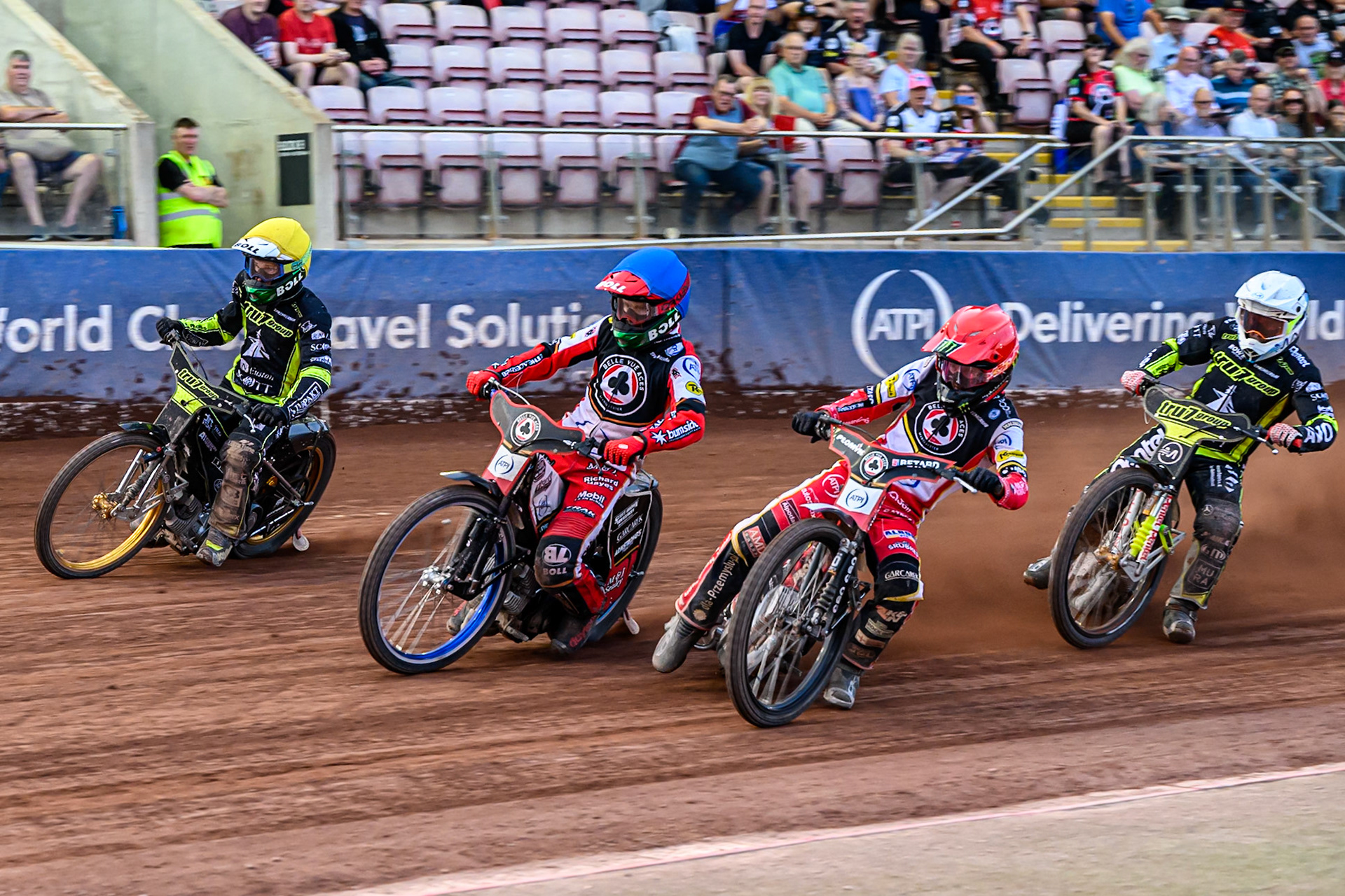 Belle Vue Aces' Dan Bewley  in Red and Belle Vue Aces' Brady Kurtz  in Blue leading Ipswich Witches' Emil Saifutdinov  in White and Ipswich Witches' Jason Doyle  in Yellow during the Rowe Motor Oil Premiership match between Belle Vue Aces and Ipswich Witches at the National Speedway Stadium, Manchester on Monday 30th June 2025. (Photo: Ian Charles | MI News)