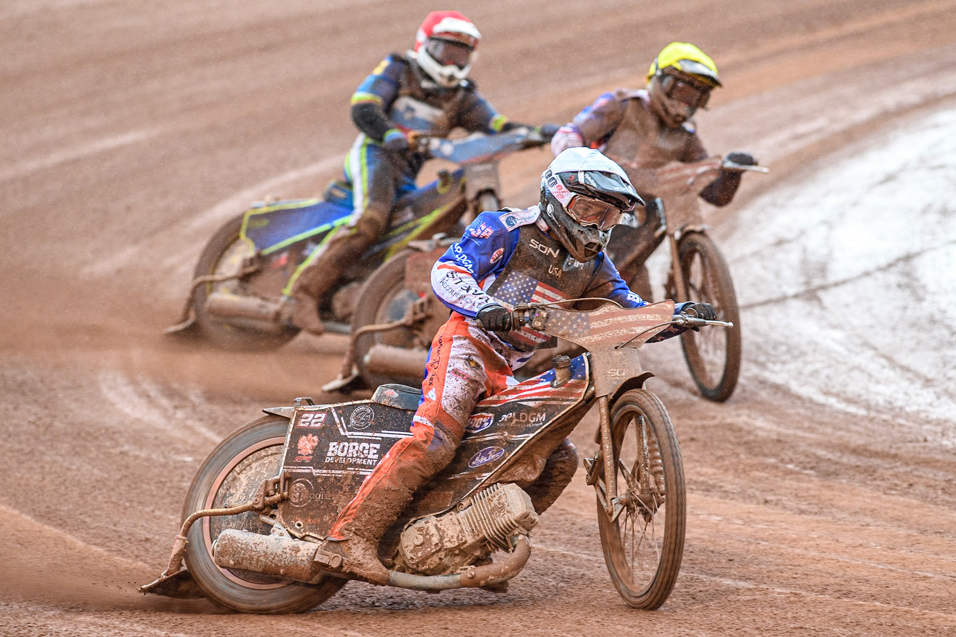 Luke Becker of the USA in White leading Gino Manzares of the USA in Yellow and Anze Grmek of Slovenia in Red during the Monster Energy FIM Speedway of Nation Semi Final 2 at the National Speedway Stadium, Manchester on Wednesday 10th July 2024. (Photo: Ian Charles | MI News)