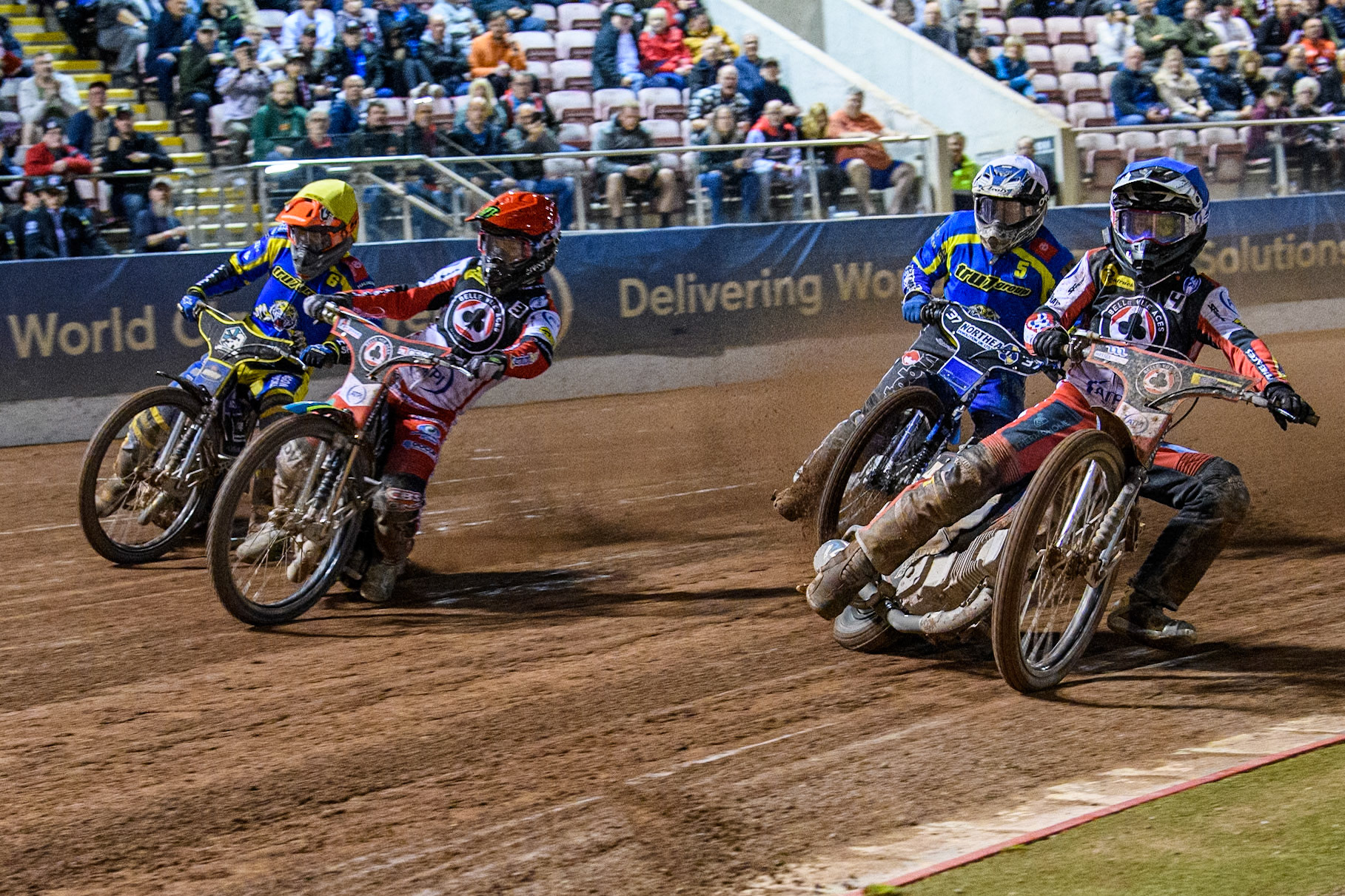Belle Vue Aces' Ben Cook  in Blue rides inside Belle Vue Aces' Jaimon Lidsey  in Red with Sheffield Tigers' Guest Rider Chris Harris  in White and Sheffield Tigers' Jason Edwards  in Yellow behind during the Rowe Motor Oil Premiership Play Off Semi Final 2, 1st Leg match between Belle Vue Aces and Sheffield Tigers at the National Speedway Stadium, Manchester on Monday 16th September 2024. (Photo: Ian Charles | MI News)