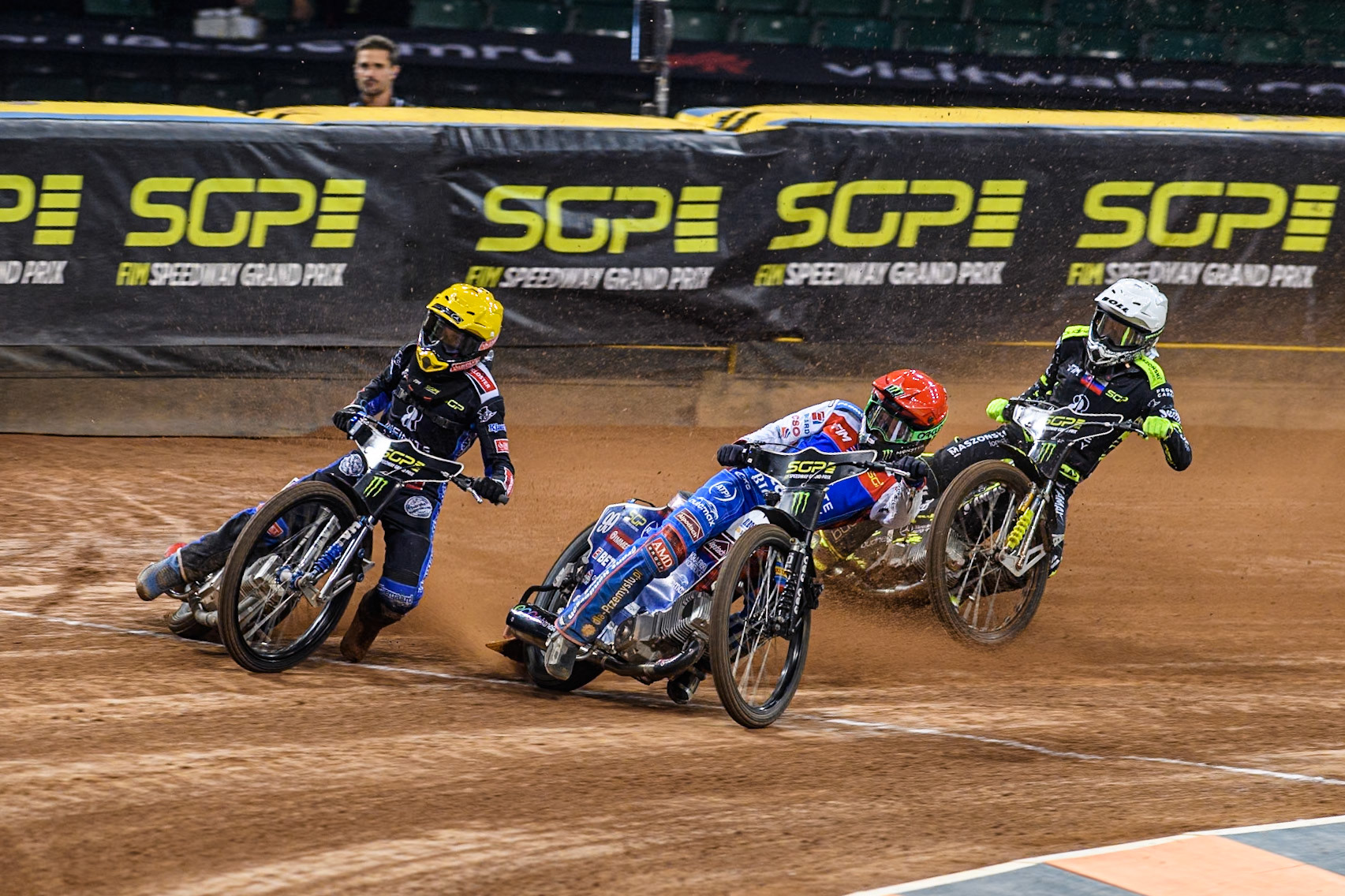Daniel Bewley (99) of Great Britain in Red rides inside Leon Madsen (30) of Denmark in Yellow with Martin Vaculik (54) of Slovakia in White behind during the FIM Speedway Grand Prix of Great Britain at The Principality Stadium, Cardiff on Saturday 17th August 2024. (Photo: Ian Charles | MI News)