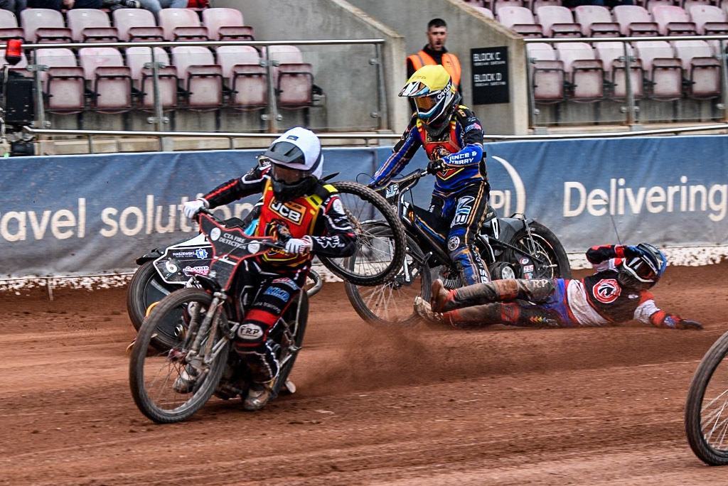 Belle Vue Colts' Harry Fletcher in Blue rears and falls between Leicester Lion Cubs' Guest Rider Ben Morley in White and Leicester Lion Cubs' Eli Meadows in Yellow during the WSRA National Development League match between Belle Vue Colts and Leicester Lion Cubs at the National Speedway Stadium, Manchester on Friday 18th April 2025. (Photo: Ian Charles | MI News)