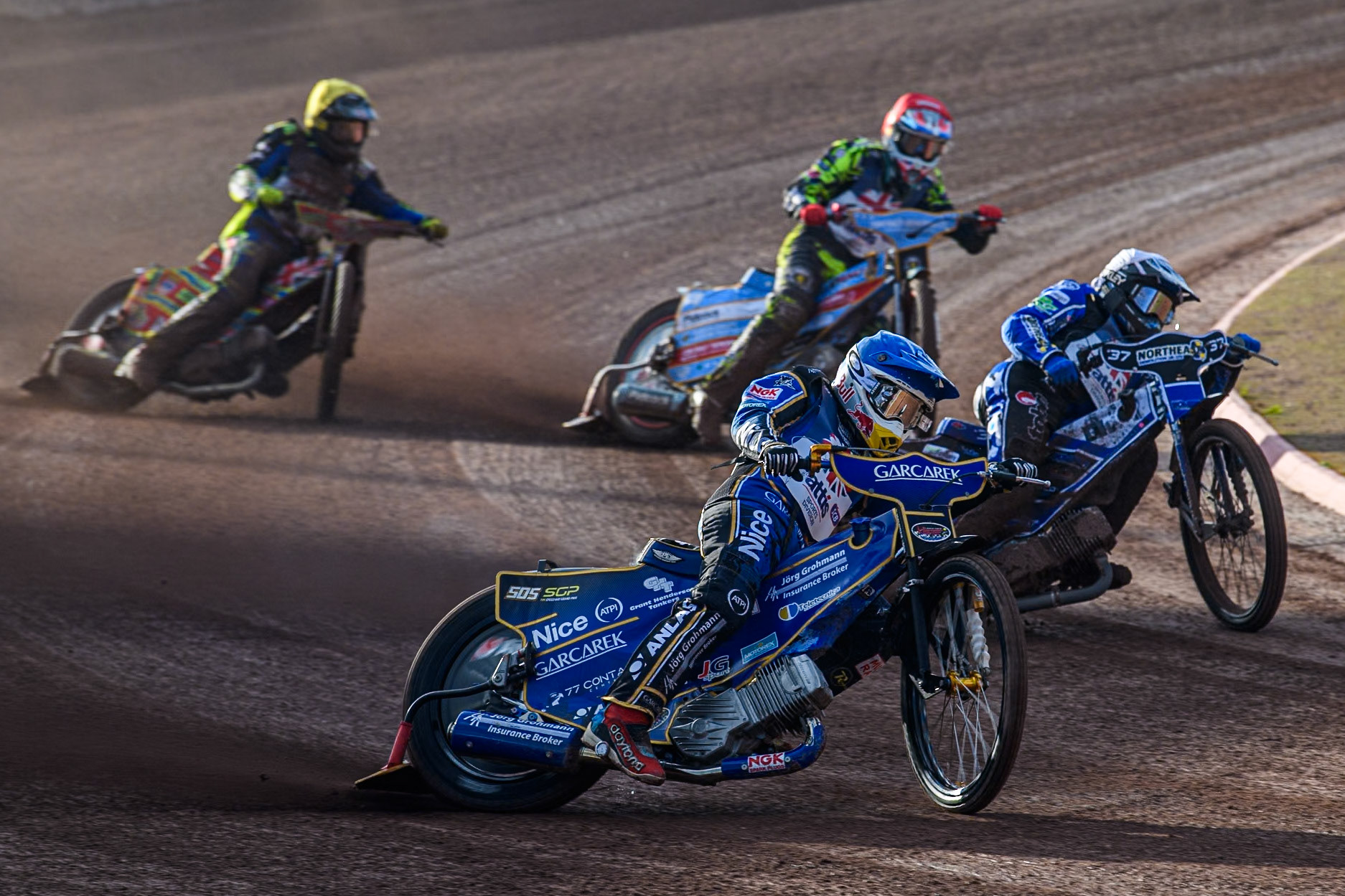 Robert Lambert in Blue rides outside Chris Harris in White with Drew Kemp in Red and Simon Lambert in Yellow behind during the Attis Insurance Sports Division British Speedway Championship Final at the National Speedway Stadium, Manchester on Saturday 8th June 2024. (Photo: Ian Charles | MI News)