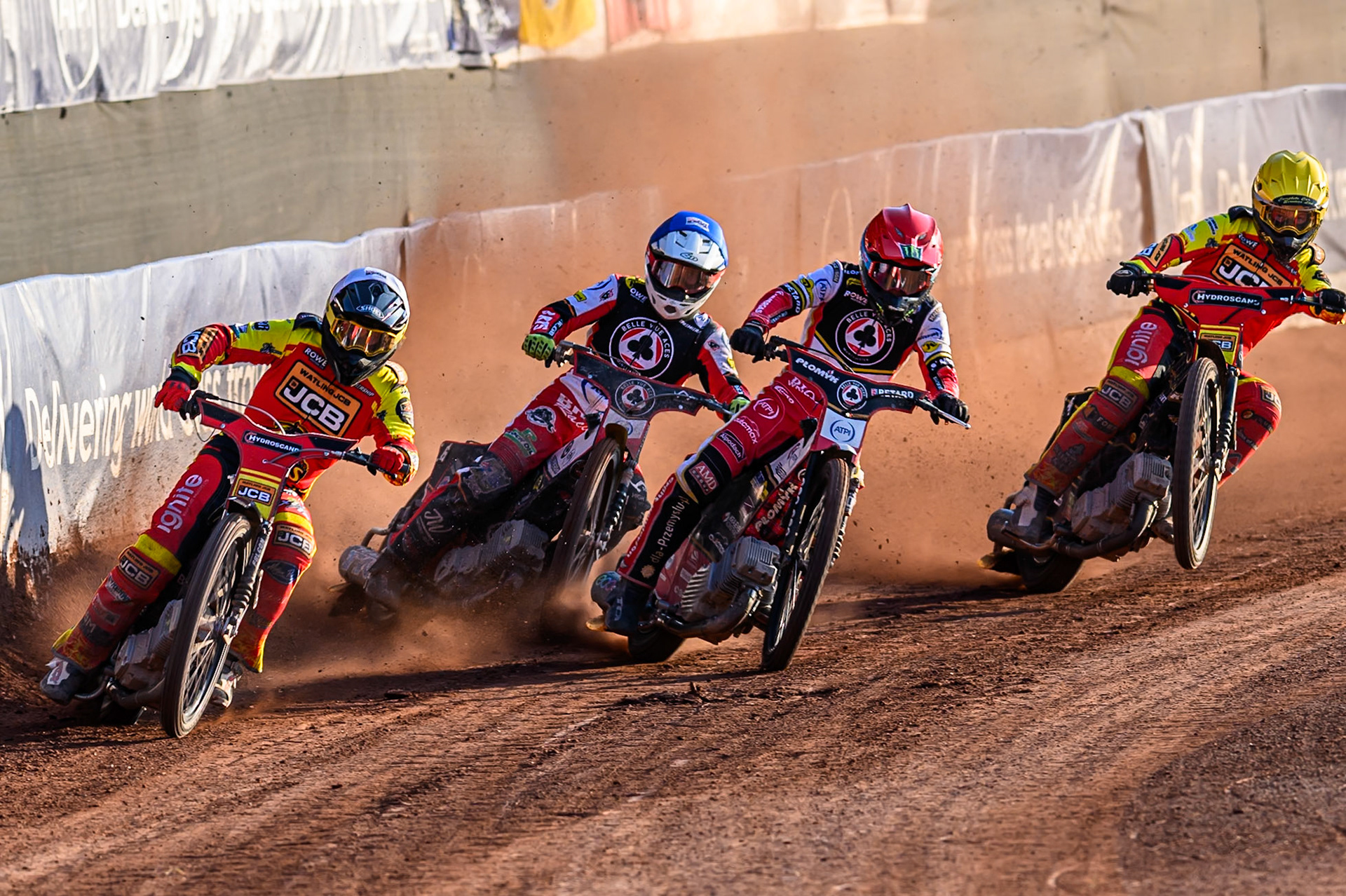 Leicester Lions' Ryan Douglas  in White rides outside Belle Vue Aces' Tate Zischke in Blue, Belle Vue Aces' Dan Bewley in Red and Leicester Lions' Kyle Howarth  in Yellow during the Rowe Motor Oil Premiership match between Belle Vue Aces and Leicester Lions at the National Speedway Stadium, Manchester on Monday 14th July 2025. (Photo: Ian Charles | MI News)