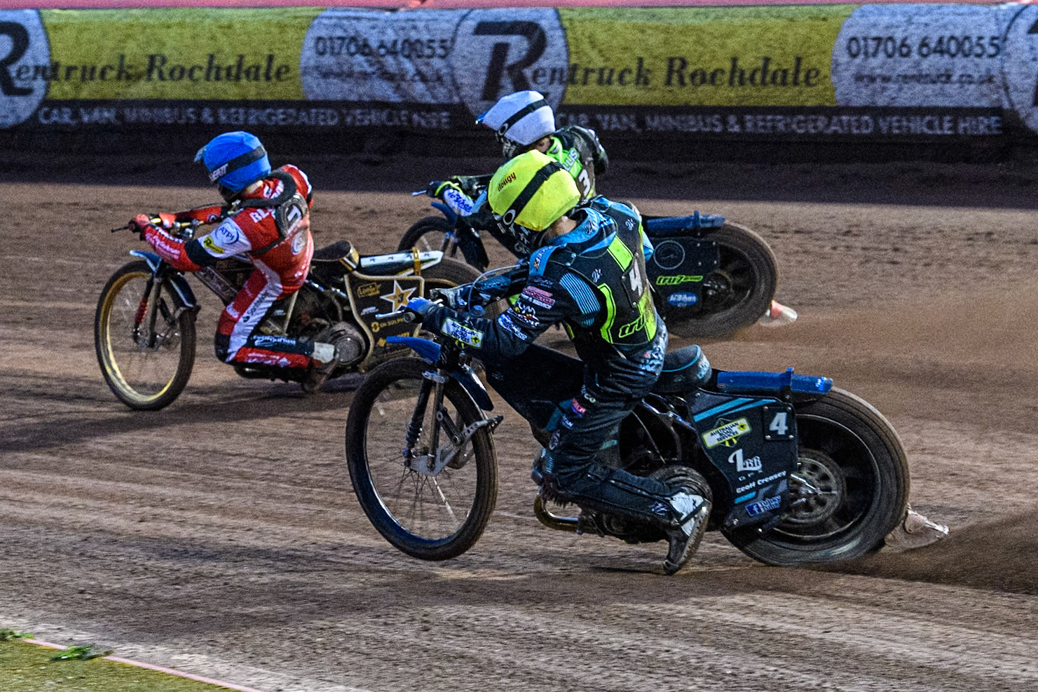 Ipswich Witches' Guest Ryan Douglas in Yellow and Ipswich Witches' Adam Ellis in White chase Belle Vue Aces' Norick Blödorn in Blue during the Rowe Motor Oil Premiership match between Belle Vue Aces and Ipswich Witches at the National Speedway Stadium, Manchester on Monday 22nd April 2024. (Photo: Ian Charles | MI News)