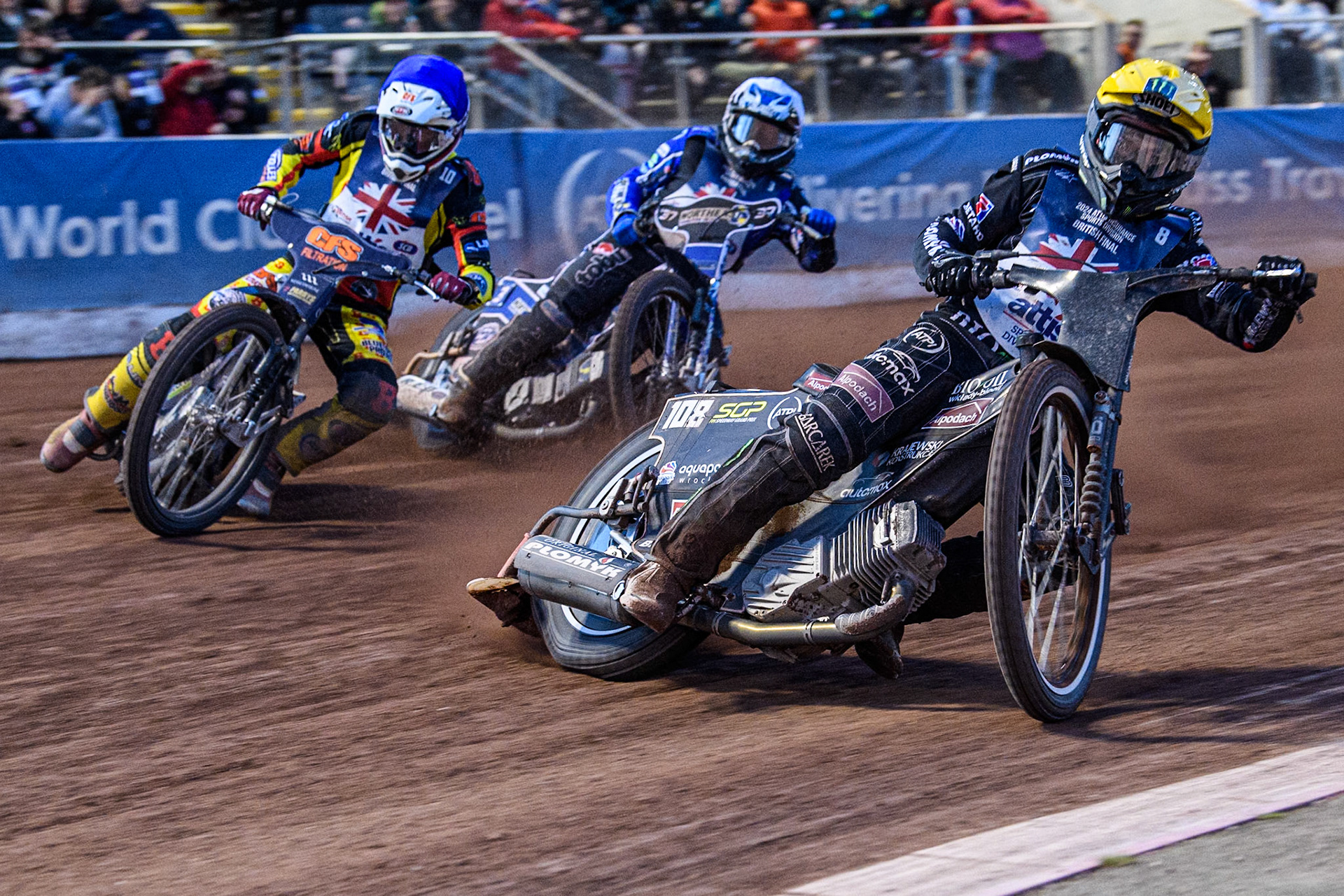 Tai Woffinden in Yellow forces his way to the lead in the Semi Final ahead of Steve Worrall in Blue and Chris Harris in White during the Attis Insurance Sports Division British Speedway Championship Final at the National Speedway Stadium, Manchester on Saturday 8th June 2024. (Photo: Ian Charles | MI News)