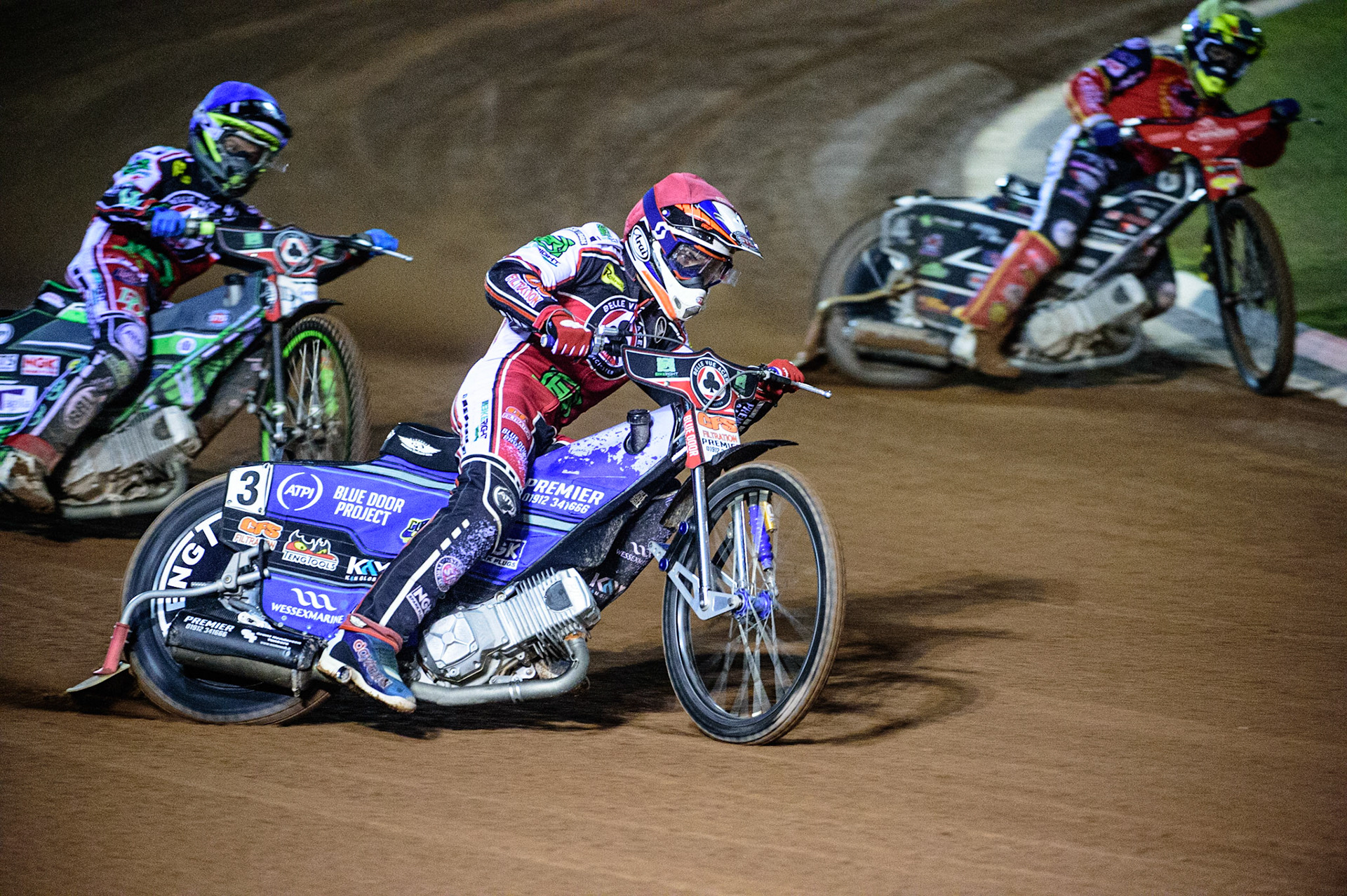 MANCHESTER, UK. OCT 11TH  Steve Worrall  (Red) outside Scott Nicholls  (Yellow) with Charles Wright  (Blue) behind during the SGB Premiership Grand Final 1st Leg between Belle Vue Aces and Peterborough Panthers at the National Speedway Stadium, Manchester on Monday 11th October 2021. (Credit: Ian Charles | MI News)