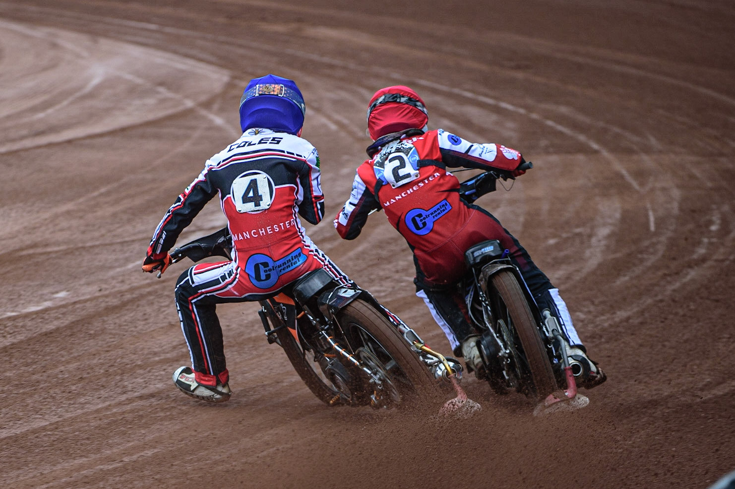 MANCHESTER, UK. APR 15TH Sam McGurk  (Red) passes his team mate Connor Coles  (Blue) during the National Development League match between Belle Vue Colts and Plymouth Centurions at the National Speedway Stadium, Manchester on Friday 15th April 2022. (Credit: Ian Charles | MI News)