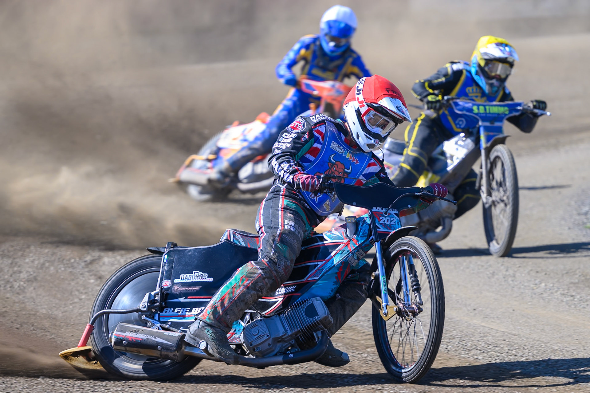 Alfie Bowtell of Buxton Bulls in Red leading Dayle Wood of Edinburgh Monarchs Academy in Yellow and Jordy Loftus of Edinburgh Monarchs Academy in White  during the WSRA National Development League match between Buxton Bulls and Edinburgh Monarchs Academy at Hi-Edge Speedway, Buxton on Sunday 14th June 2026. (Photo: Ian Charles | MI News)