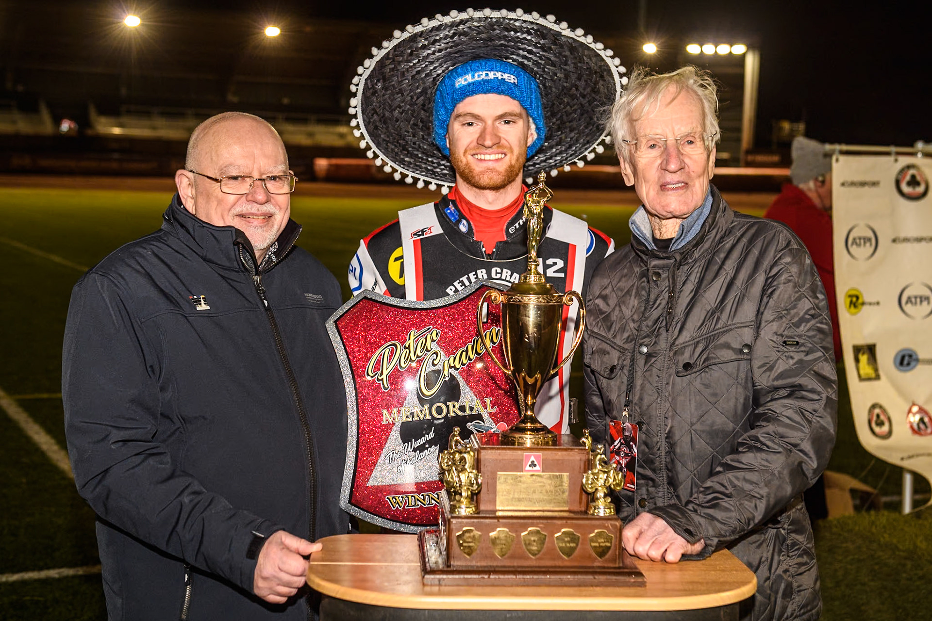 (L to R) Robert Craven, son of  Peter Craven, Brady Kurtz, and Ove Fundin with the trophy after Kurtz win during the Peter Craven Memorial Trophy meeting at the National Speedway Stadium, Manchester on Monday 18th March 2024. (Photo: Ian Charles | MI News)