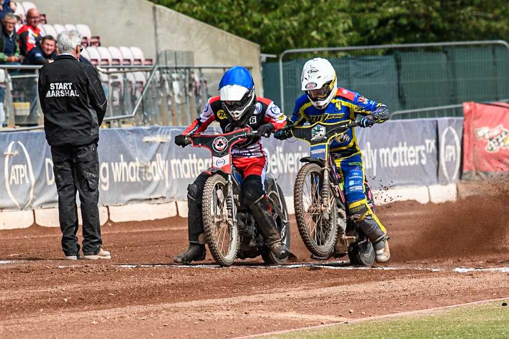 Belle Vue Aces' Antti Vuolas  in Blue and Sheffield Tigers' Josh Pickering  in White get close to each other as they leave the start during the Rowe Motor Oil Premiership match between Belle Vue Aces and Sheffield Tigers at the National Speedway Stadium, Manchester on Monday 26th August 2024. (Photo: Ian Charles | MI News)