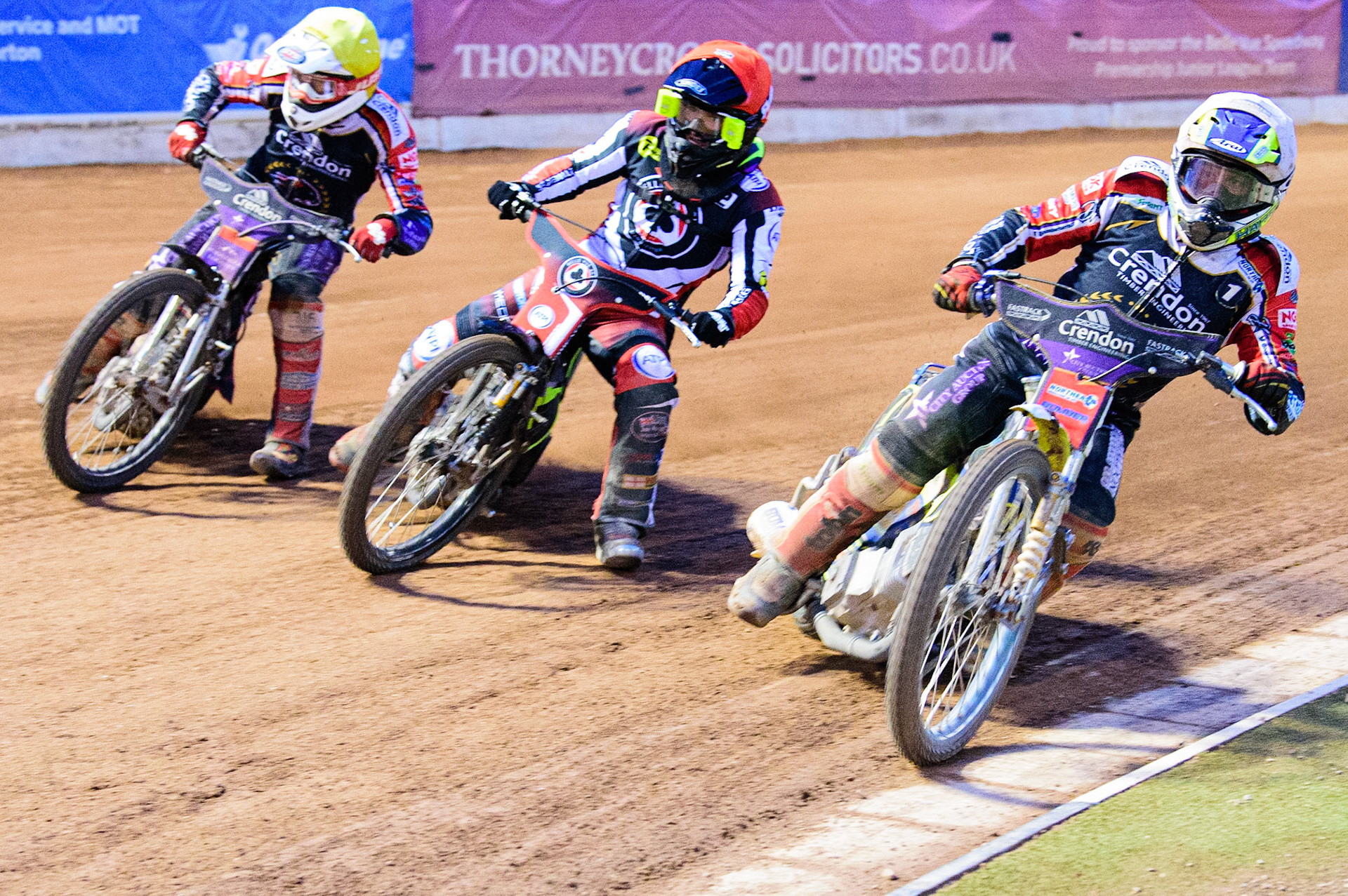 Chris Harris  (White) inside Tom Brennan (Red) and Ulrich Oostergaard  (White) during the SGB Premiership match between Belle Vue Aces and Peterborough at the National Speedway Stadium, Manchester on Monday 25th July 2022. (Credit: Ian Charles | MI News
