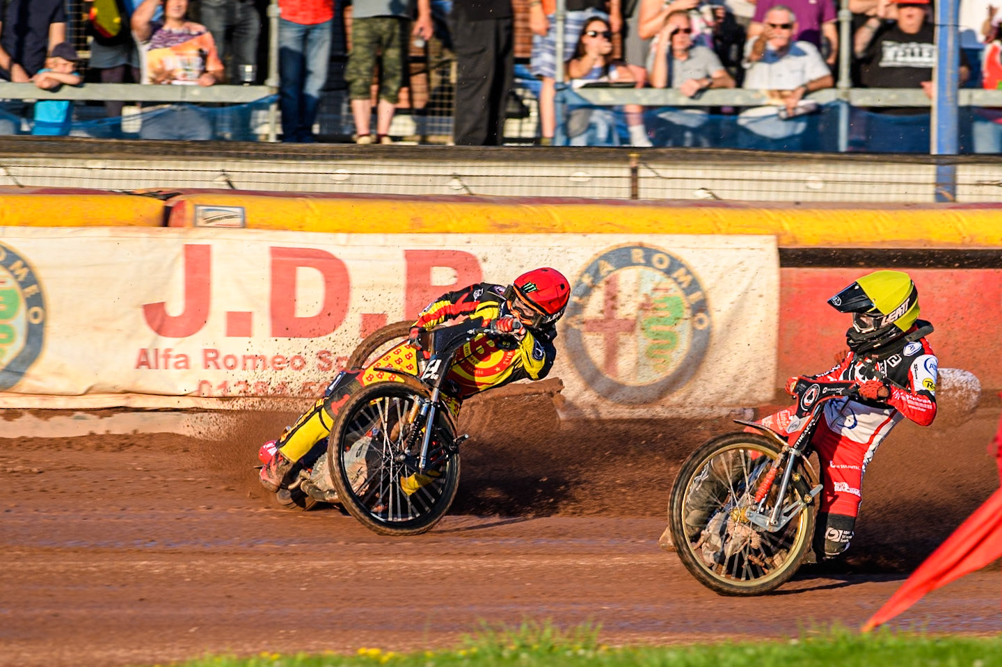Belle Vue Aces' Brady Kurtz falls on the first turn of the opening lap behind Birmingham Brummies' Freddie Lindgren in Red and Belle Vue Aces' Norick Blodorn in Yellow during the Rowe Motor Oil Premiership match between Birmingham Brummies and Belle Vue Aces at Perry Bar Stadium, Birmingham on Monday 29th July 2024. (Photo: Ian Charles | MI News)