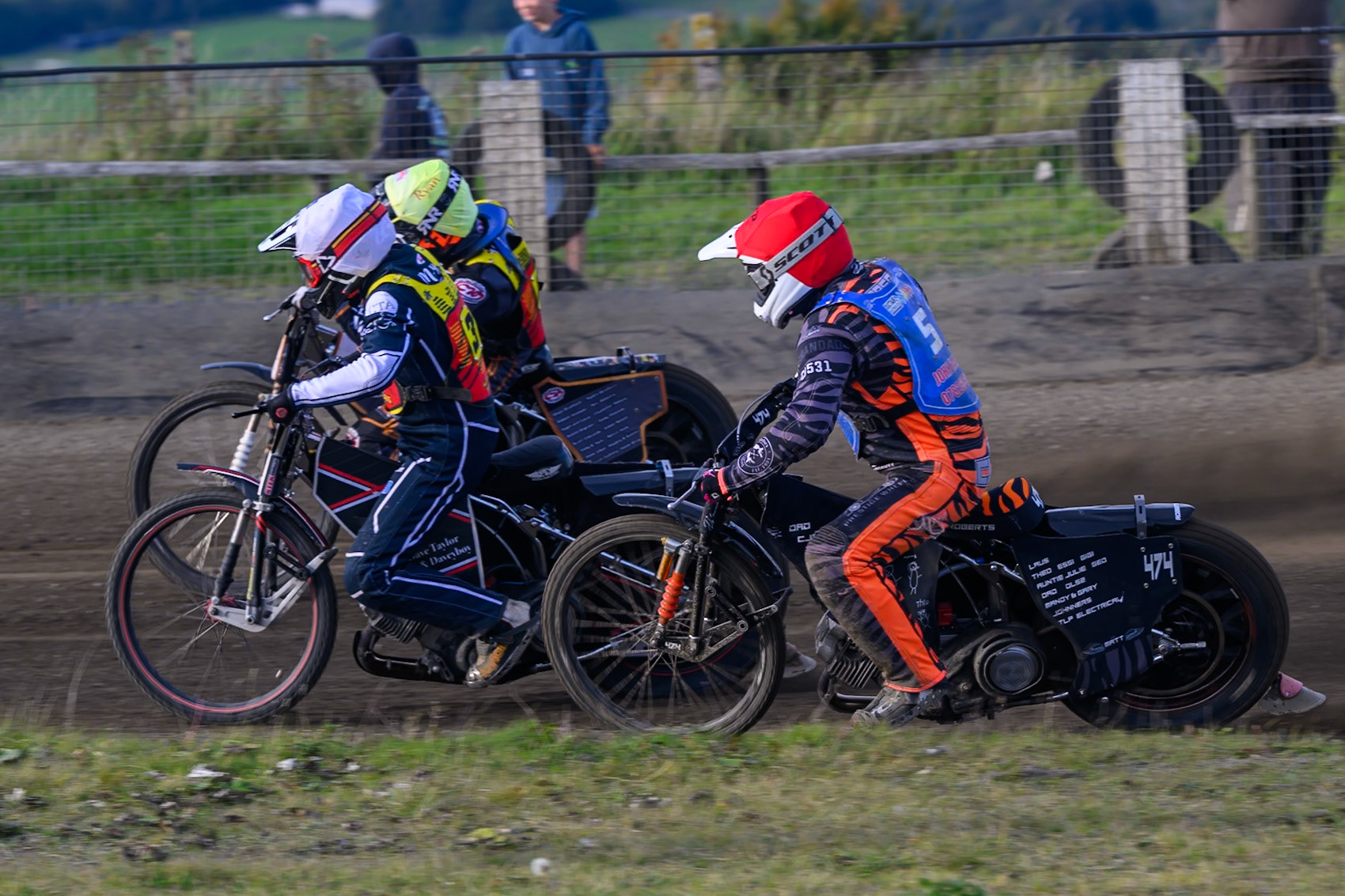 Ben Morley of Leicester Lion Cubs  in White  and Ryan Ingram of Leicester Lion Cubs   in Yellow  block the path of Jack Roberts of Buxton Bulls   in Red during the WSRA National Development League match between Buxton Bulls and Leicester Lion Cubs at Hi-Edge Speedway, Buxton on Sunday 4th October 2026. (Photo: Ian Charles | MI News)