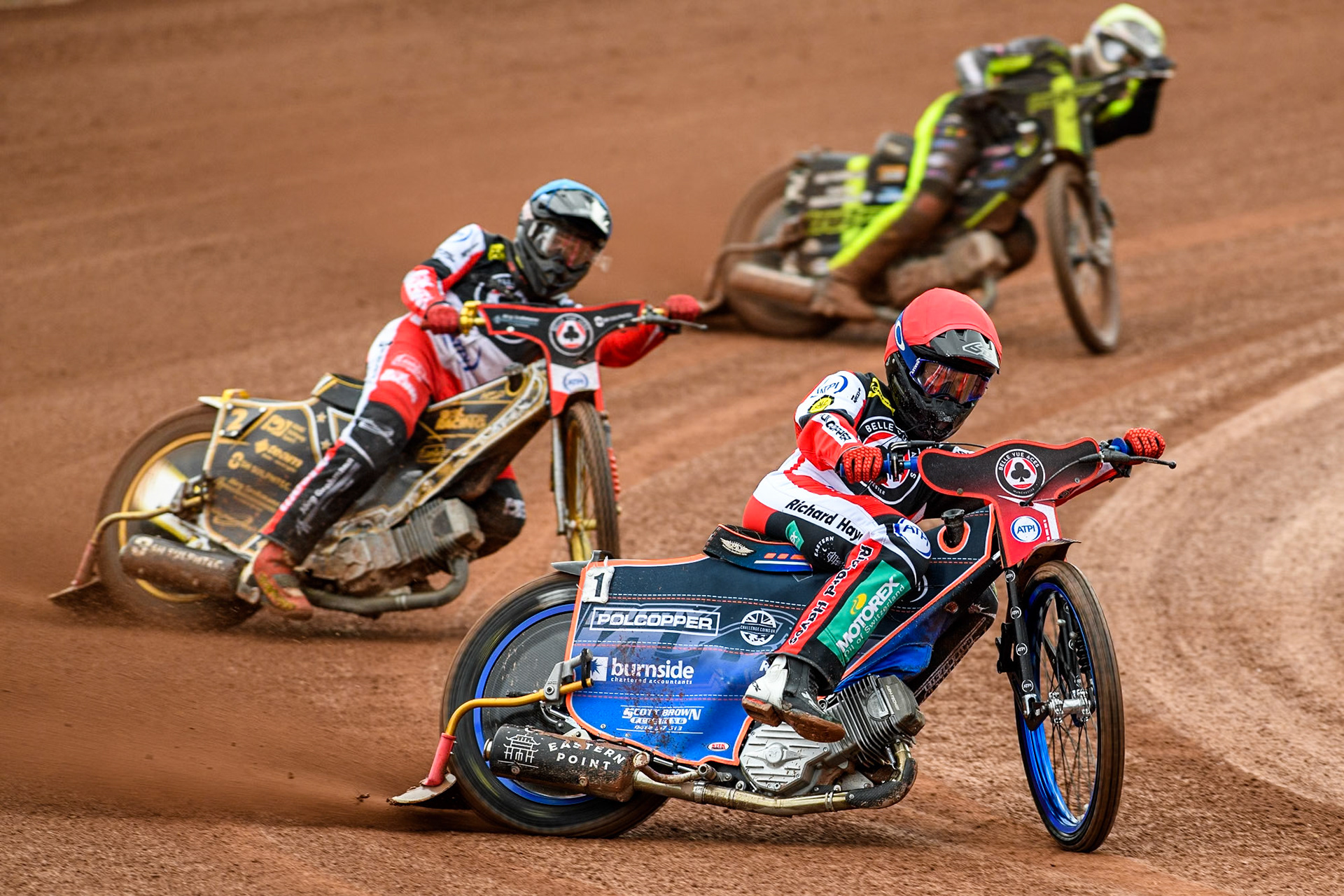 Belle Vue Aces' Brady Kurtz  in Red leading team mate Belle Vue Aces' Norick Blodorn  in Blue and Ipswich Witches' Dan Thompson in Yellow during the Rowe Motor Oil Premiership match between Belle Vue Aces and Ipswich Witches at the National Speedway Stadium, Manchester on Monday 1st July 2024. (Photo: Ian Charles | MI News)