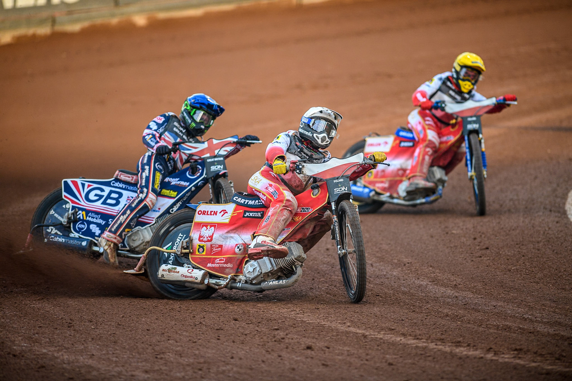 Dominik Kubera of Poland in White leading Dan Bewley of Great Britain in Blue and Bartosz Zmarzlik of Poland in Yellow during the Monster Energy FIM Speedway of Nation Final at the National Speedway Stadium, Manchester on Saturday 13th July 2024. (Photo: Ian Charles | MI News)