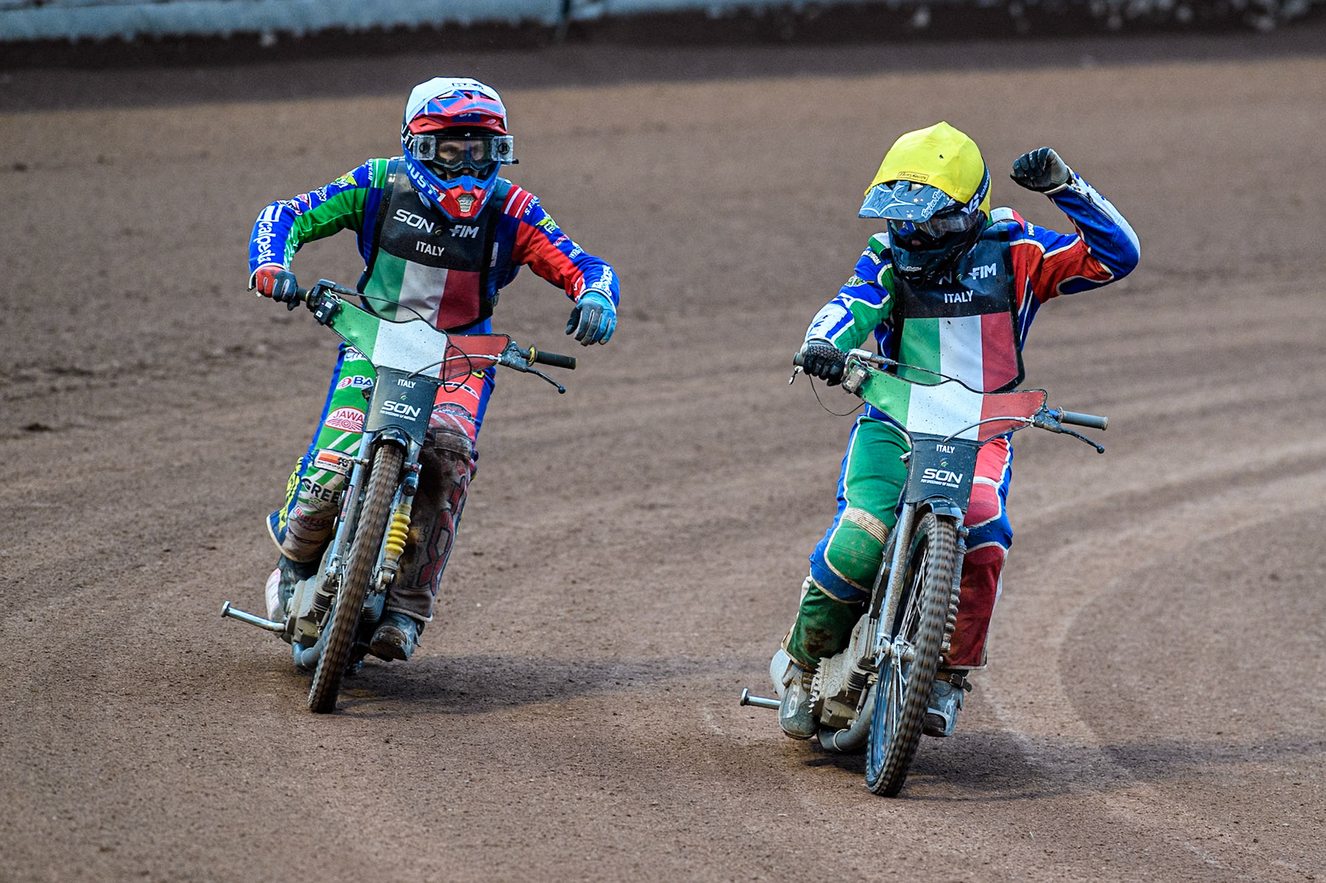 Nicolas Vicentin of Italy in Yellow waves to the crowd after their final heat ahead of Paco Castagna of Italy in White during the Monster Energy FIM Speedway of Nations Semi-Final 1 at the National Speedway Stadium, Manchester on Tuesday 9th July 2024. (Photo: Ian Charles | MI News)