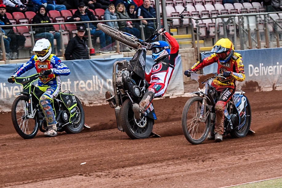 Belle Vue Colts' Billy Budd rears at the start between Leicester Lion Cubs' Guest Rider Darryl Ritchings in White and Leicester Lion Cubs' Sonny Springer in Yellow during the WSRA National Development League match between Belle Vue Colts and Leicester Lion Cubs at the National Speedway Stadium, Manchester on Friday 18th April 2025. (Photo: Ian Charles | MI News)