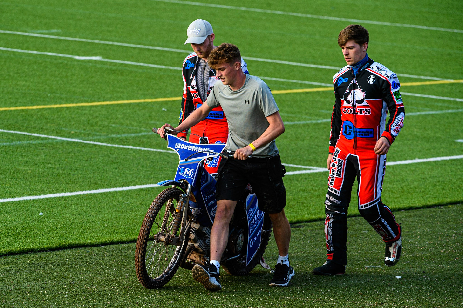 MANCHESTER, UK. JULY 23RD  Harry McGurks machine is taken back to the pits by his mechanic and Paul Bowen  (left) and Connor Coles  during the National Development League match between Belle Vue Colts and Eastbourne Seagulls at the National Speedway Stadium, Manchester on Friday 23rd July 2021. (Credit: Ian Charles | MI News)