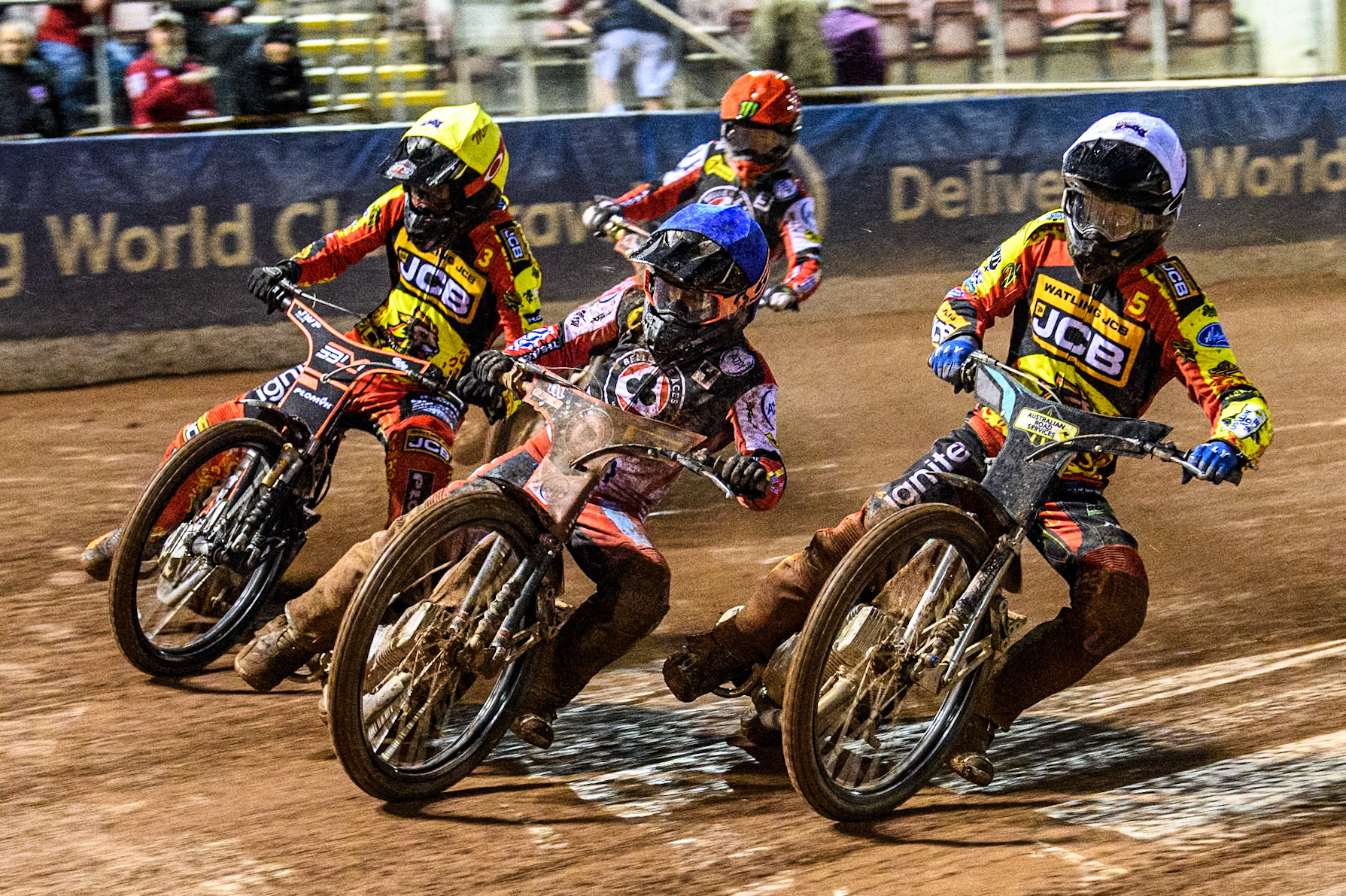 Ben Cook of Belle Vue Aces in Blue leading Ryan Douglas of Leicester Lions in Yellow Sam Masters of Leicester Lions in Yellow and Jaimon Lidsey of Belle Vue Aces in Red during the Rowe Motor Oil Premiership match between Belle Vue Aces and Leicester Lions at the National Speedway Stadium, Manchester on Saturday 6th April 2024. (Photo: Ian Charles | MI News)