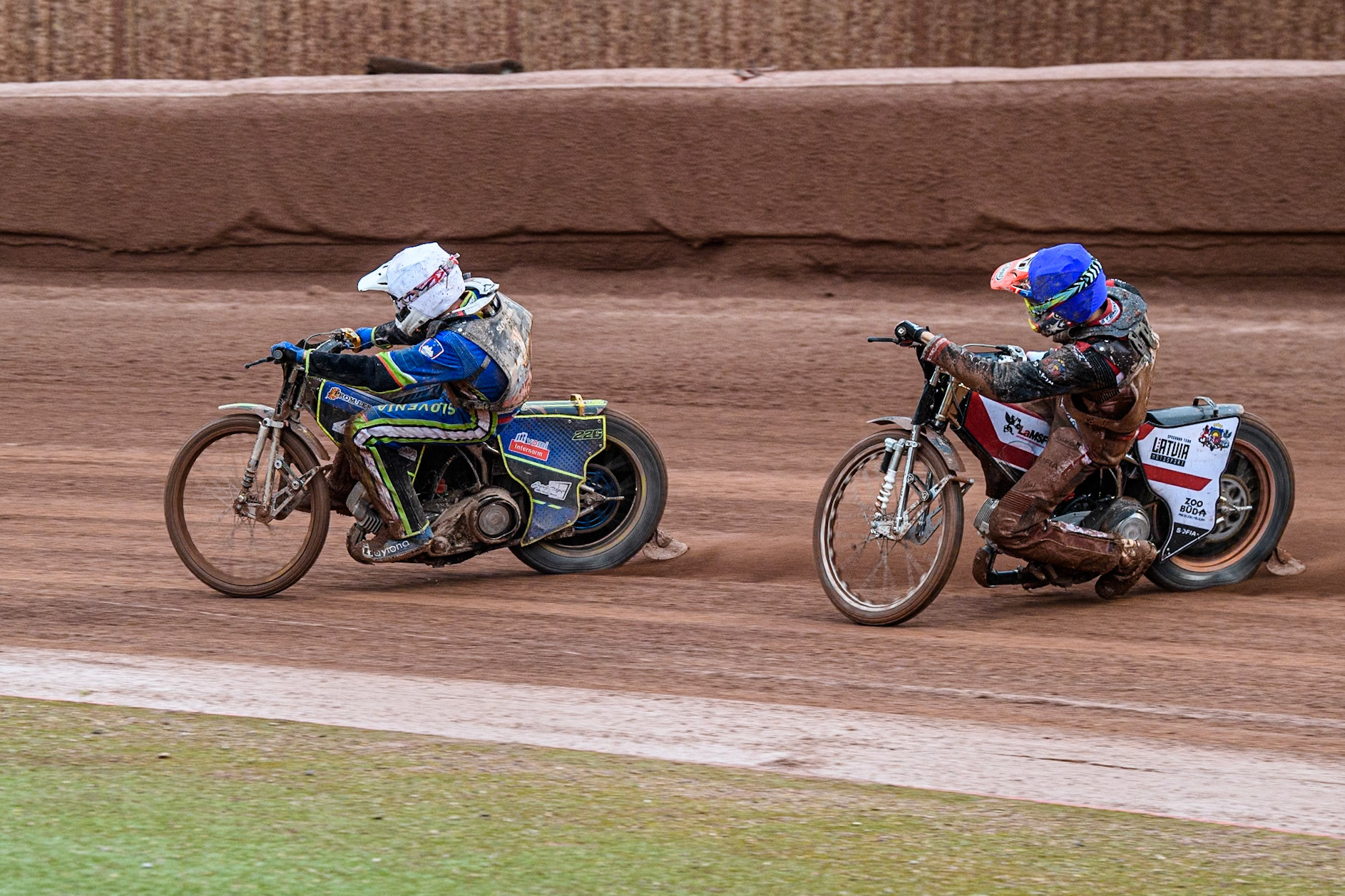 Anze Grmek of Slovenia in White leading Daniils Kolodinskis of Latvia in Blue during the Monster Energy FIM Speedway of Nation Semi Final 2 at the National Speedway Stadium, Manchester on Wednesday 10th July 2024. (Photo: Ian Charles | MI News)