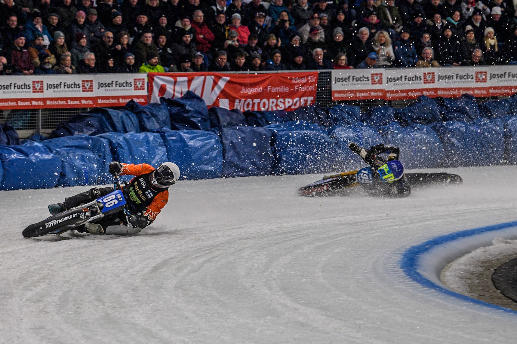 Finland's Aki Ala-Riihimäki (66) (White) leads  as Sweden's Martin Haarahiltunen (199)  (Blue) crashes out during the FIM Ice Speedway Gladiators World Championship Final 2 at the Max-Aicher-Arena, Inzell on Sunday 24 March 2024. (Photo: Ian Charles | MI News)