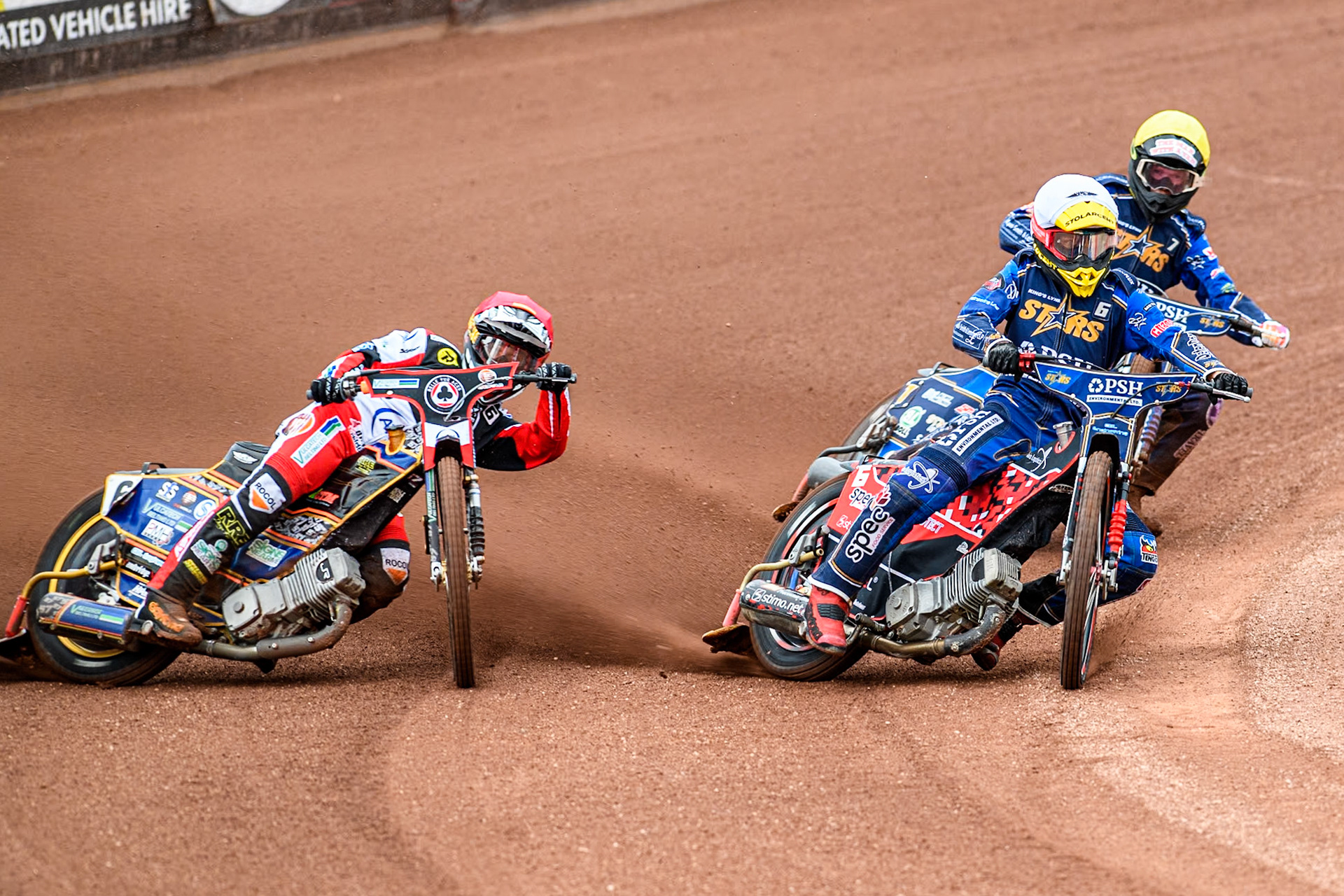 Belle Vue Aces' Connor Mountain in Red rides outside King Lynn Stars' Patryk Wojdylo in White and King Lynn Stars' Anders Rowe in Yellow during the Rowe Motor Oil Premiership match between Belle Vue Aces and King's Lynn Stars at the National Speedway Stadium, Manchester on Monday 20th May 2024. (Photo: Ian Charles | MI News)