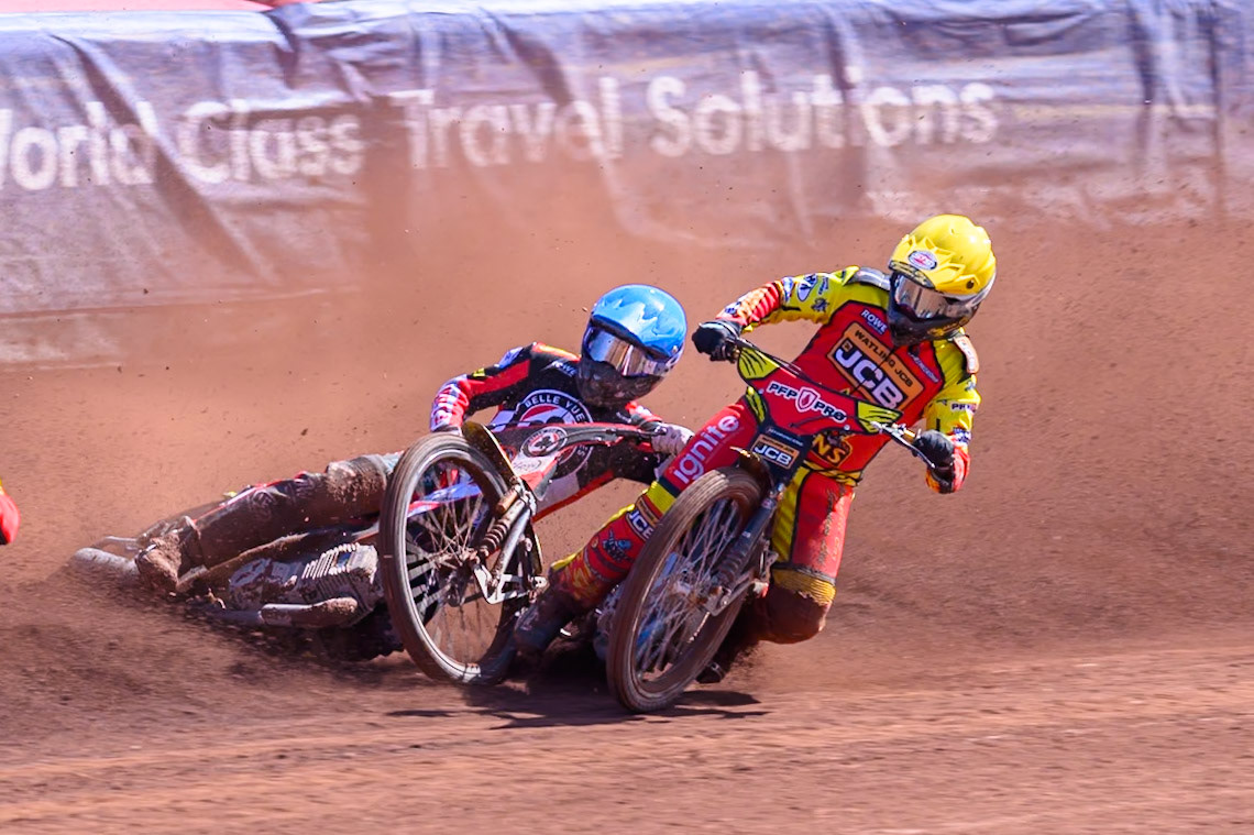 Kyle Howarth of Leicester Lions  in Yellow brings down Tate Zischke of Belle Vue Aces in Blue during the Knockout Cup Northern Section match between Belle Vue Aces and Leicester Lions at the National Speedway Stadium, Manchester on Monday 6th April 2026. (Photo: Ian Charles | MI News)