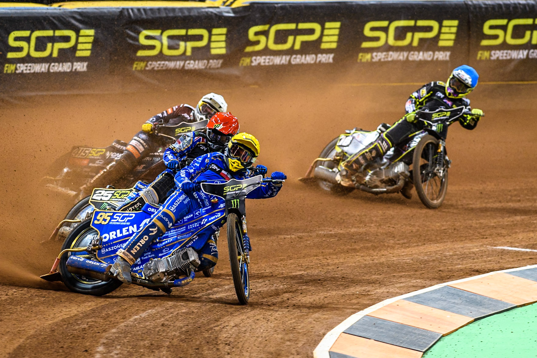 Bartosz Zmarzlik (95) of Poland  in Yellow leading Jack Holder (25) of Australia in Red, Jack Holder (25) of Australia in Red and Tom Brennan (16) Wild card rider of Great Britain in Blue during the FIM Speedway Grand Prix of Great Britain at The Principality Stadium, Cardiff on Saturday 17th August 2024. (Photo: Ian Charles | MI News)