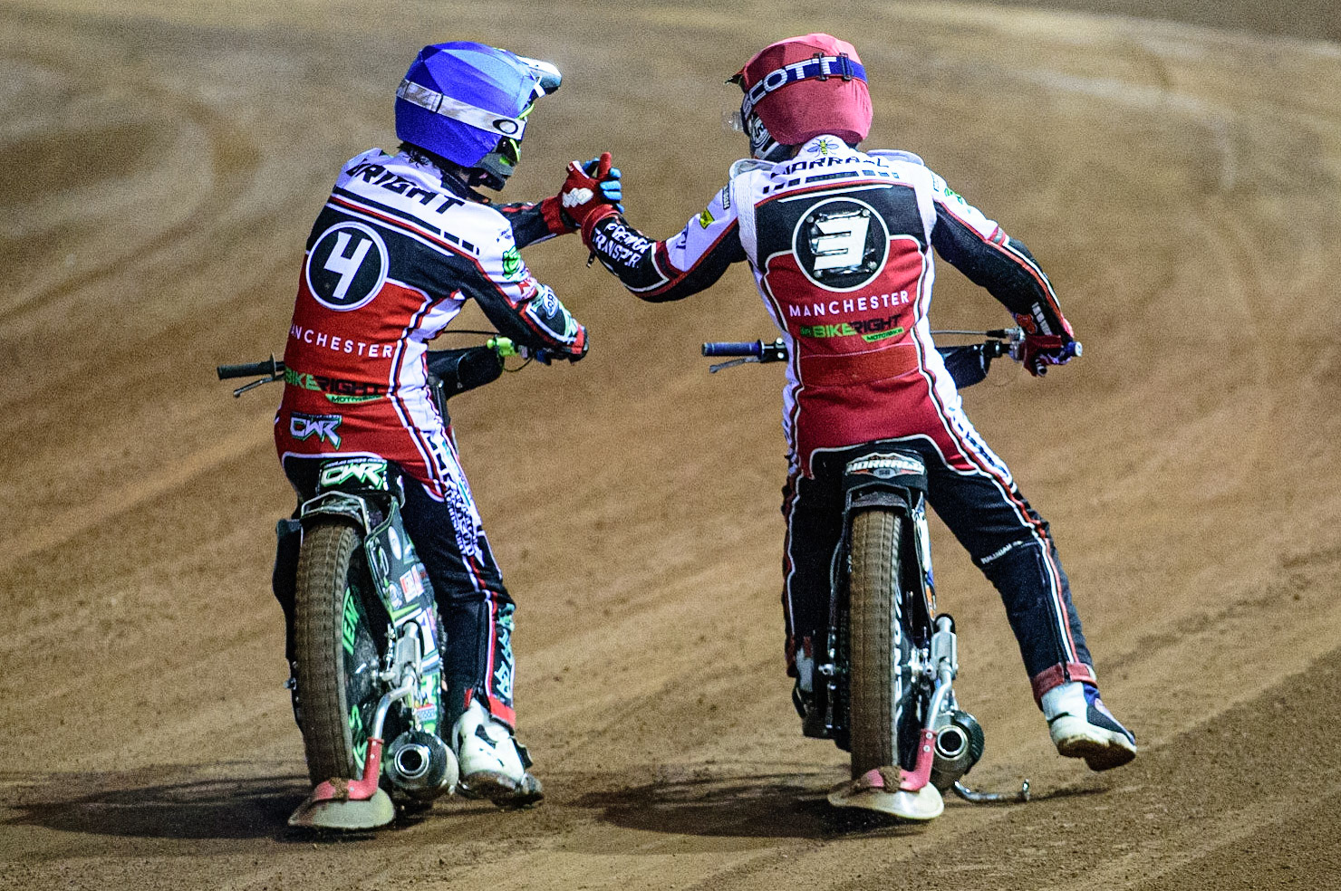 MANCHESTER, UK. OCT 11TH  Charles Wright  (Blue) and Steve Worrall   (Red) celebrate their win during the SGB Premiership Grand Final 1st Leg between Belle Vue Aces and Peterborough Panthers at the National Speedway Stadium, Manchester on Monday 11th October 2021. (Credit: Ian Charles | MI News)