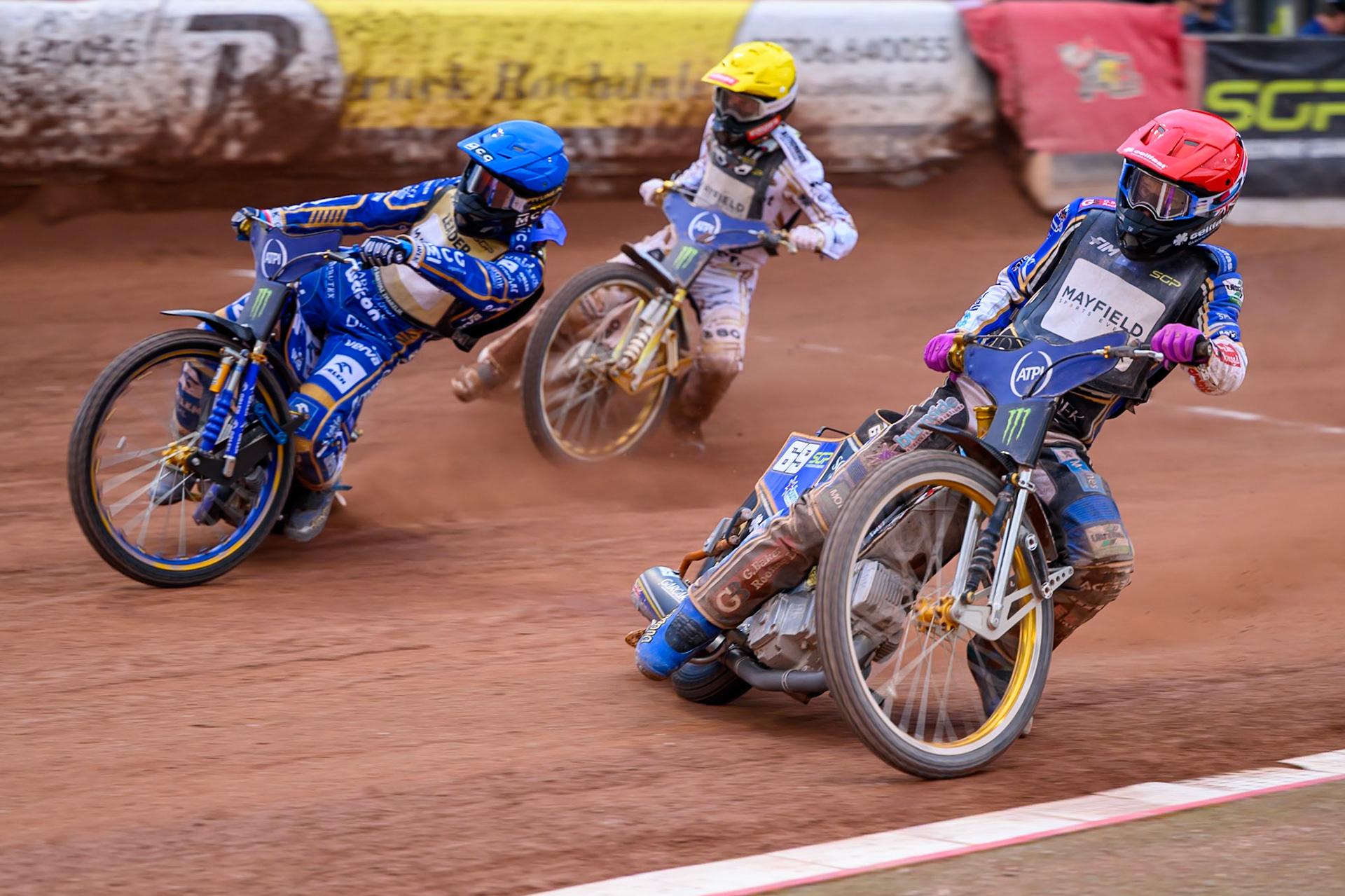 Jason Doyle (69) of Australia in Red leading Bartosz Zmarzlik (95) of Poland in Blue and Anders Thomsen (105) of Denmark in Yellow during the ATPI  FIM Speedway GP of Manchester at the National Speedway Stadium, Manchester on Saturday 6th June 2026. (Photo: Ian Charles | MI News)