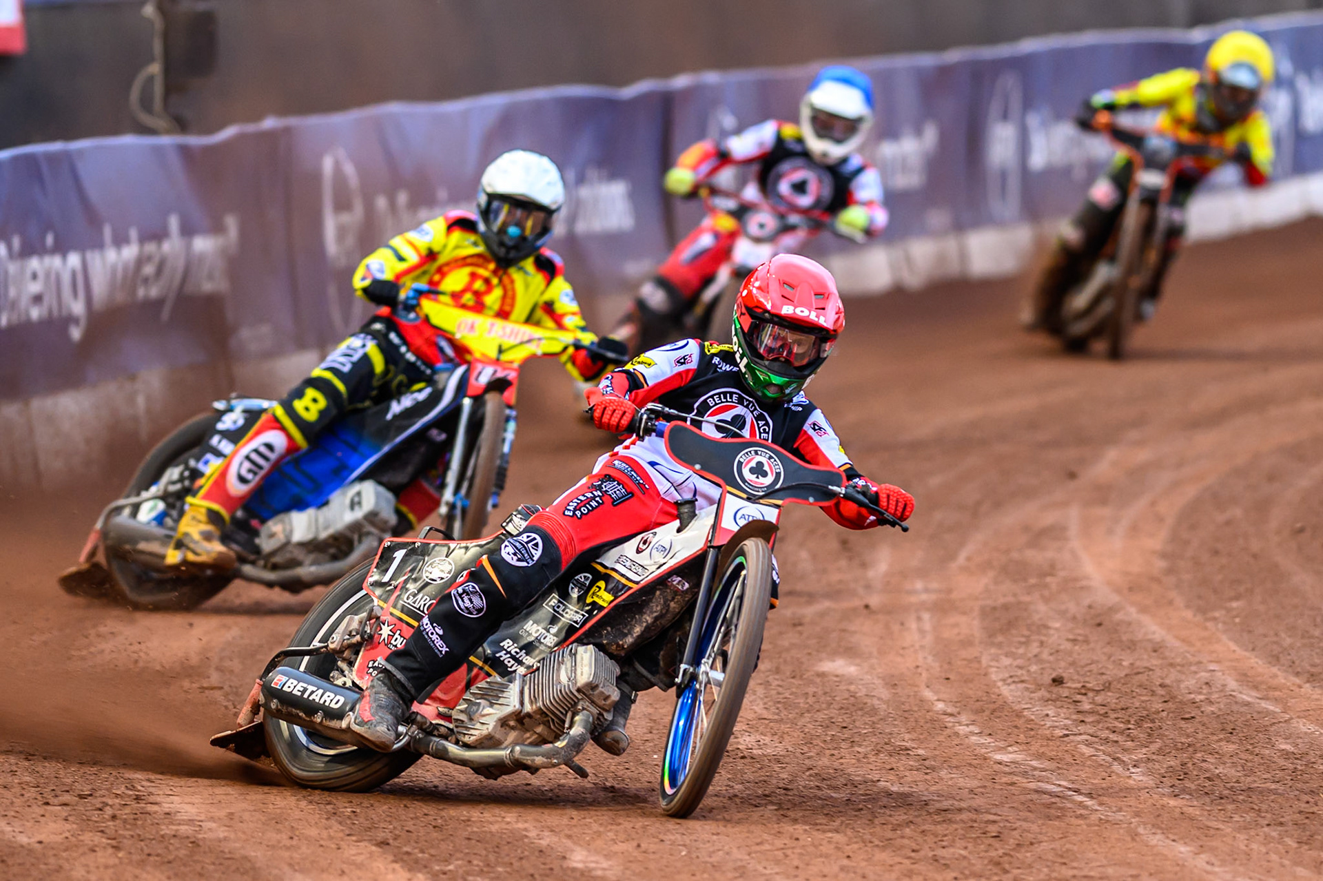 Belle Vue Aces' Brady Kurtz  in Red leading Birmingham Brummies' Matej Zagar  in White, Belle Vue Aces' Jake Mulford  in Blue and Birmingham Brummies' Guest Rider Jack Smith in Yellow during the Rowe Motor Oil Premiership match between Belle Vue Aces and Birmingham Brummies at the National Speedway Stadium, Manchester on Monday 7th July 2025. (Photo: Ian Charles | MI News)