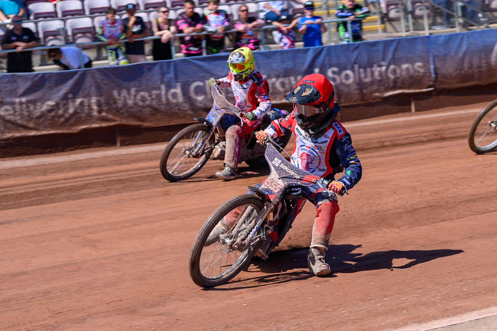 BRITISH YOUTH CHAMPIONSHIP 125cc Fraser Buckle (555) in Red rides inside Ella Marshall (12)  in Yellow during the British Youth Championship (125cc) at the National Speedway Stadium, Manchester on Sunday 19th July 2026. (Photo: Ian Charles | MI News)