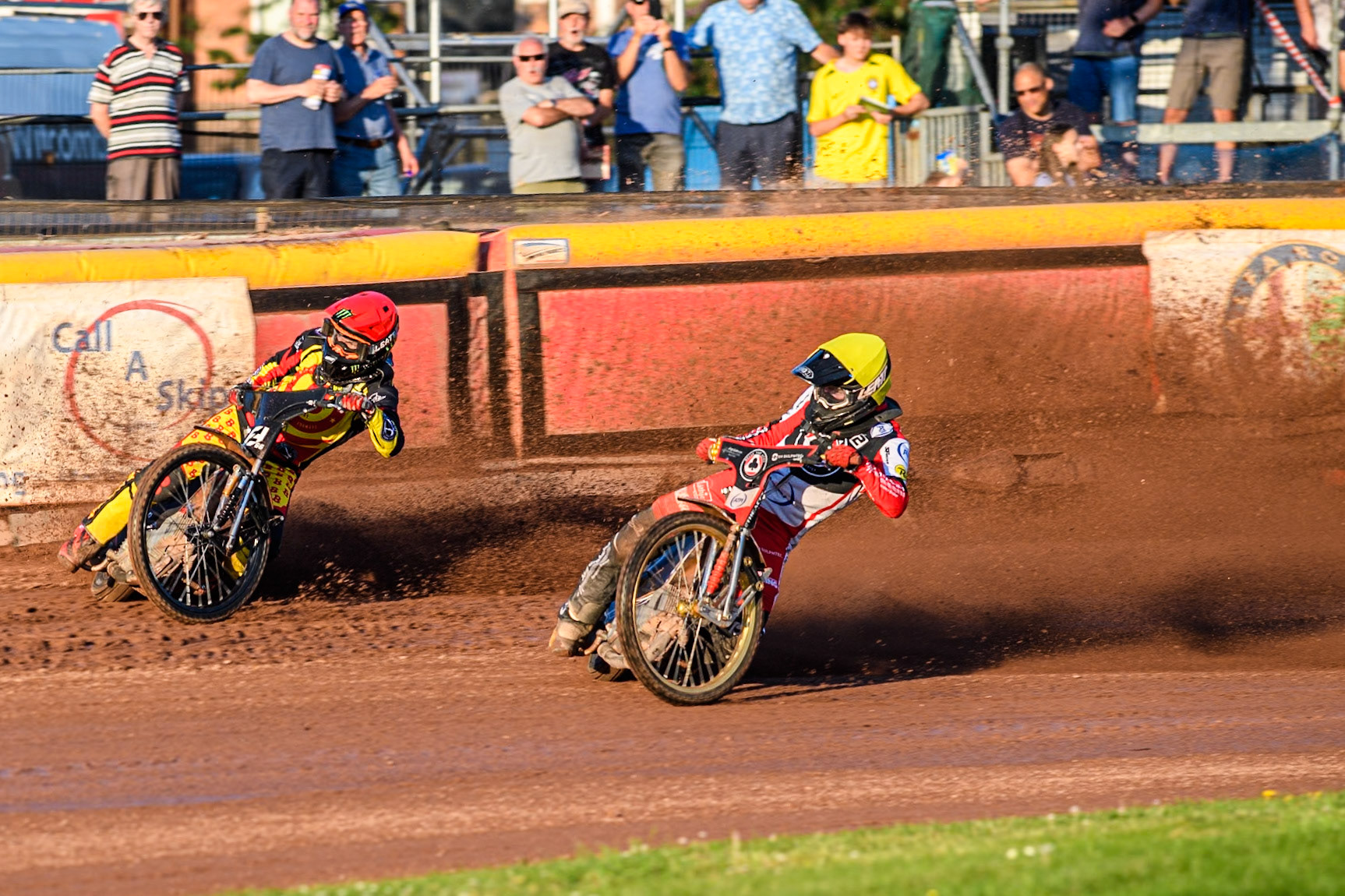 Belle Vue Aces' Brady Kurtz falls on the first turn of the opening lap behind Birmingham Brummies' Freddie Lindgren in Red and Belle Vue Aces' Norick Blodorn in Yellow during the Rowe Motor Oil Premiership match between Birmingham Brummies and Belle Vue Aces at Perry Bar Stadium, Birmingham on Monday 29th July 2024. (Photo: Ian Charles | MI News)
