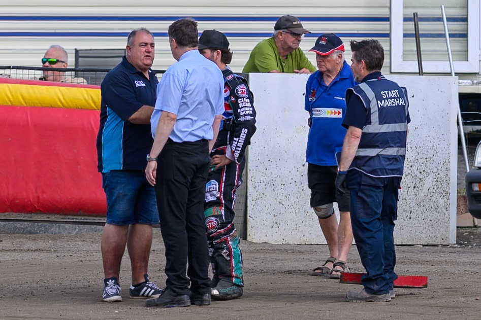 Jason Pipe, Team Manager of Kings Lynn Young Stars (Left) chats with  Referee Michael Breckon (light blue shirt) and Alfie Bowtell of Buxton Bulls  as Laurence Rogers, Team Manager of Buxton Bulls (2nd right) and Start Marshall Ron Makin (Right) listen in during the WSRA National Development League match between Buxton Bulls and King's Lynn Young Stars at Hi-Edge Speedway, Buxton on Sunday 9th August 2026. (Photo: Ian Charles | MI News)