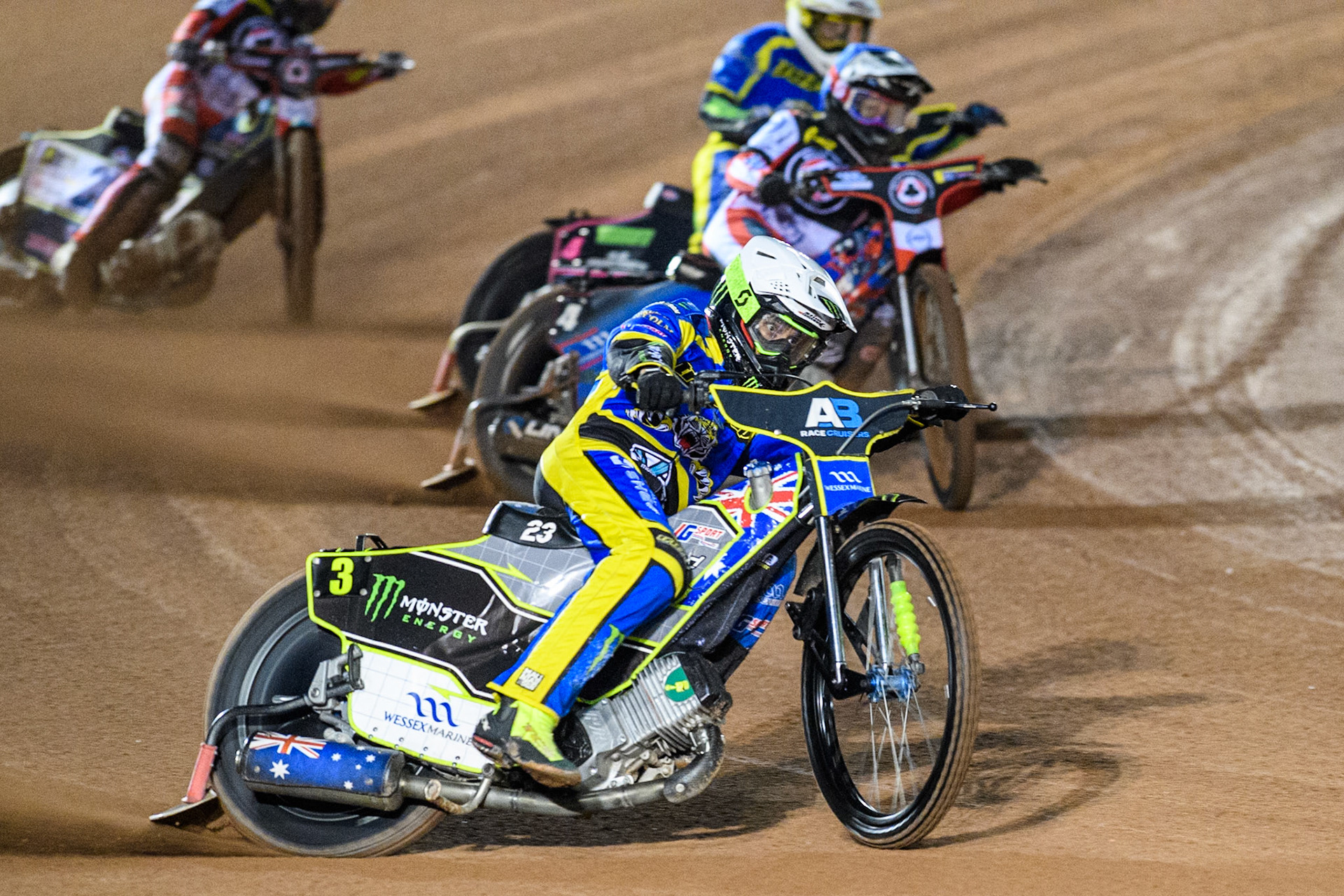 Sheffield Tigers' Chris Holder  in White leading  Belle Vue Aces' Ben Cook  in Blue and Sheffield Tigers' Josh Pickering  in Yellow  during the Rowe Motor Oil Premiership Play Off Semi Final 2, 1st Leg match between Belle Vue Aces and Sheffield Tigers at the National Speedway Stadium, Manchester on Monday 16th September 2024. (Photo: Ian Charles | MI News)