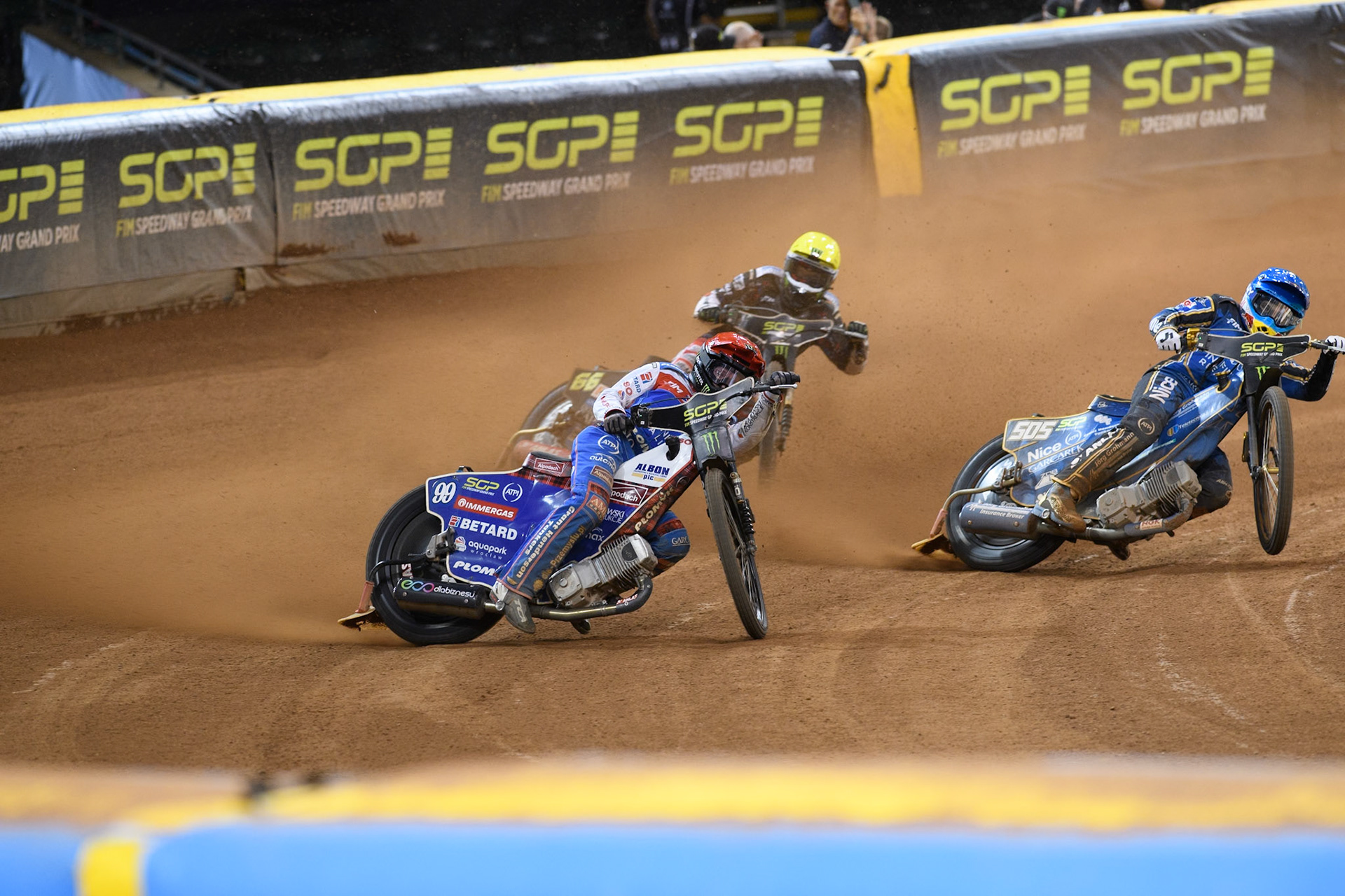 Daniel Bewley (99) of Great Britain in Red rides outside Robert Lambert (505) of Great Britain in Blue with Fredrik Lindgren (66) of Sweden in Yellow in Semi Final 2 behind during the FIM Speedway Grand Prix of Great Britain at The Principality Stadium, Cardiff on Saturday 17th August 2024. (Photo: Ian Charles | MI News)