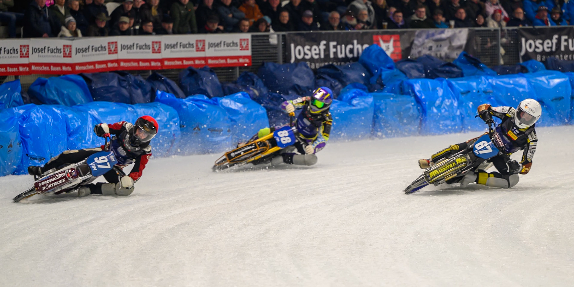 Heikki Huusko (67) of Finland  in White rides inside Ove Ledström (97) of Sweden in Red and Max Niedermaier (88) of Germany in Blue during the Ice Speedway Gladiators World Championship Final 1 at Max-Aicher-Arena, Inzell on Saturday 14th March 2026. (Photo: Ian Charles | MI News)