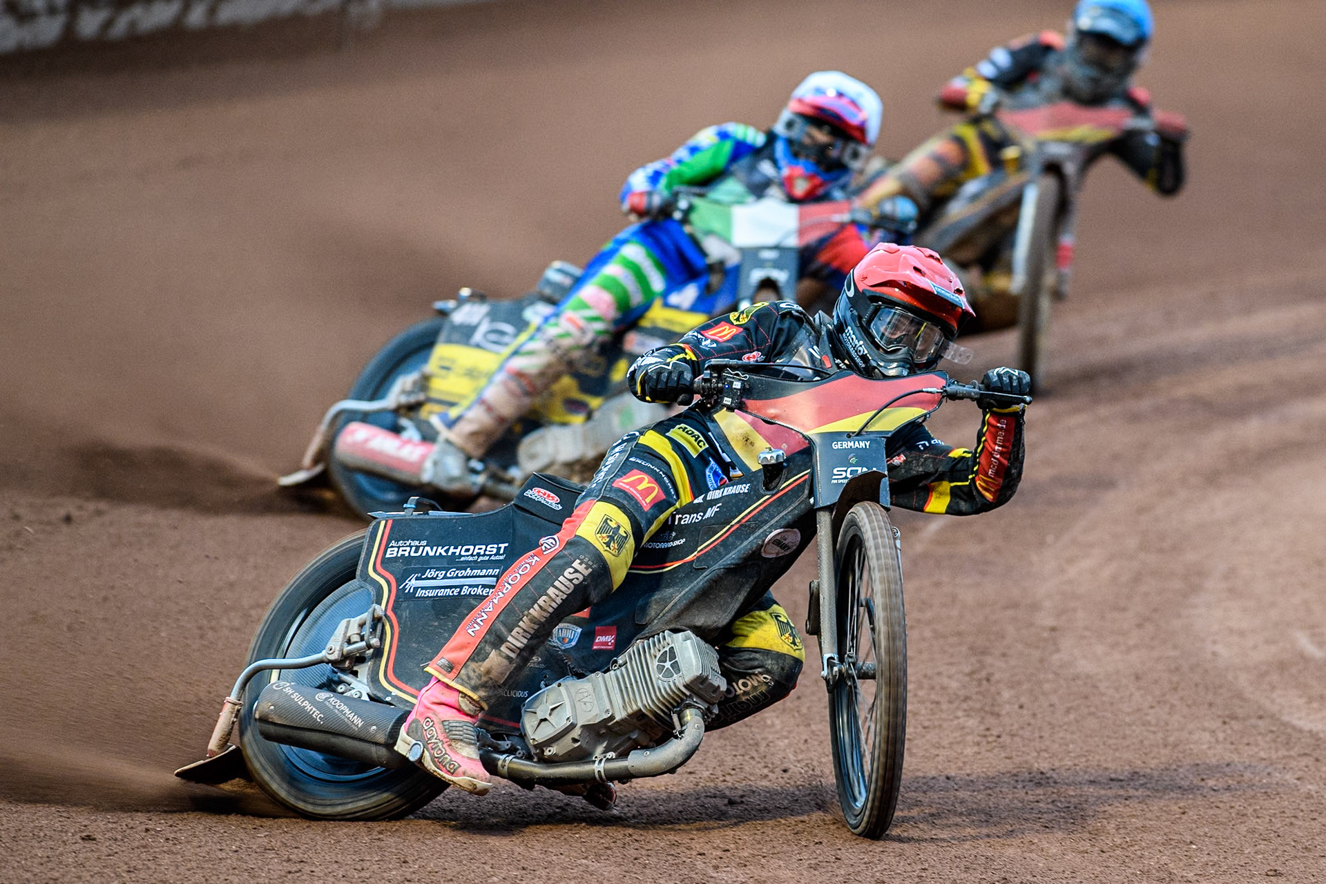 Kai Huckenbeck of Germany in Red leading Paco Castagna of Italy in White and Norick Blödorn of Germany in Blue during the Monster Energy FIM Speedway of Nations Semi-Final 1 at the National Speedway Stadium, Manchester on Tuesday 9th July 2024. (Photo: Ian Charles | MI News)