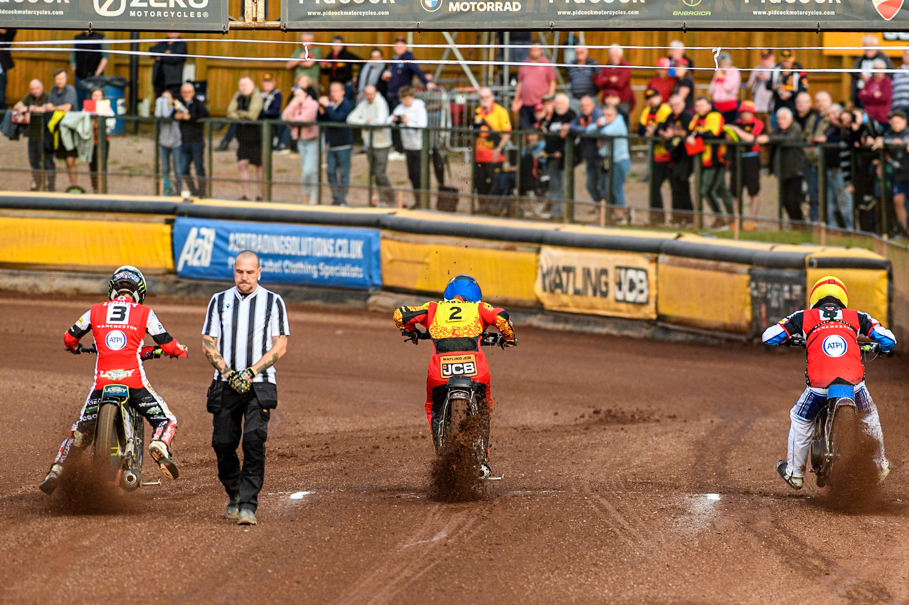 (L to R) Belle Vue Aces' Jaimon Lidsey in White, Leicester Lions' Richard Lawson in Blue and Belle Vue Aces' Antti Vuolas in Yellow leave the start in the re-run of Heat 6 during the Rowe Motor Oil Premiership match between Leicester Lions and Belle Vue Aces at the Pidcock Motorcycles Arena, Leicester on Thursday 25th July 2024. (Photo: Ian Charles | MI News)