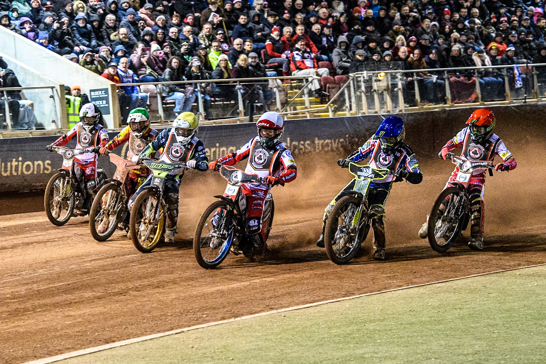 The start of the 6 rider Grand Final: Dan Bewley in Red, Chris Holder in Blue, Brady Kurtz in White, Jason Doyle in Yellow, Max Fricke in Green and Jaimon Lidsey in Black &amp; White during the Peter Craven Memorial Trophy at the National Speedway Stadium, Manchester on Monday 17th March 2025. (Photo: Ian Charles | MI News)