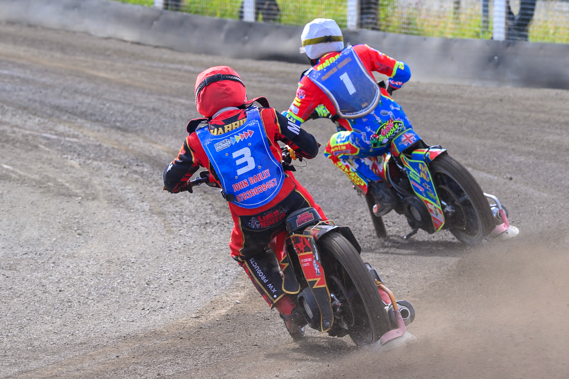 Luke Harris of Buxton Bulls  in Red chases Simon Lambert of Kings Lynn Young Stars in White during the WSRA National Development League match between Buxton Bulls and King's Lynn Young Stars at Hi-Edge Speedway, Buxton on Sunday 9th August 2026. (Photo: Ian Charles | MI News)