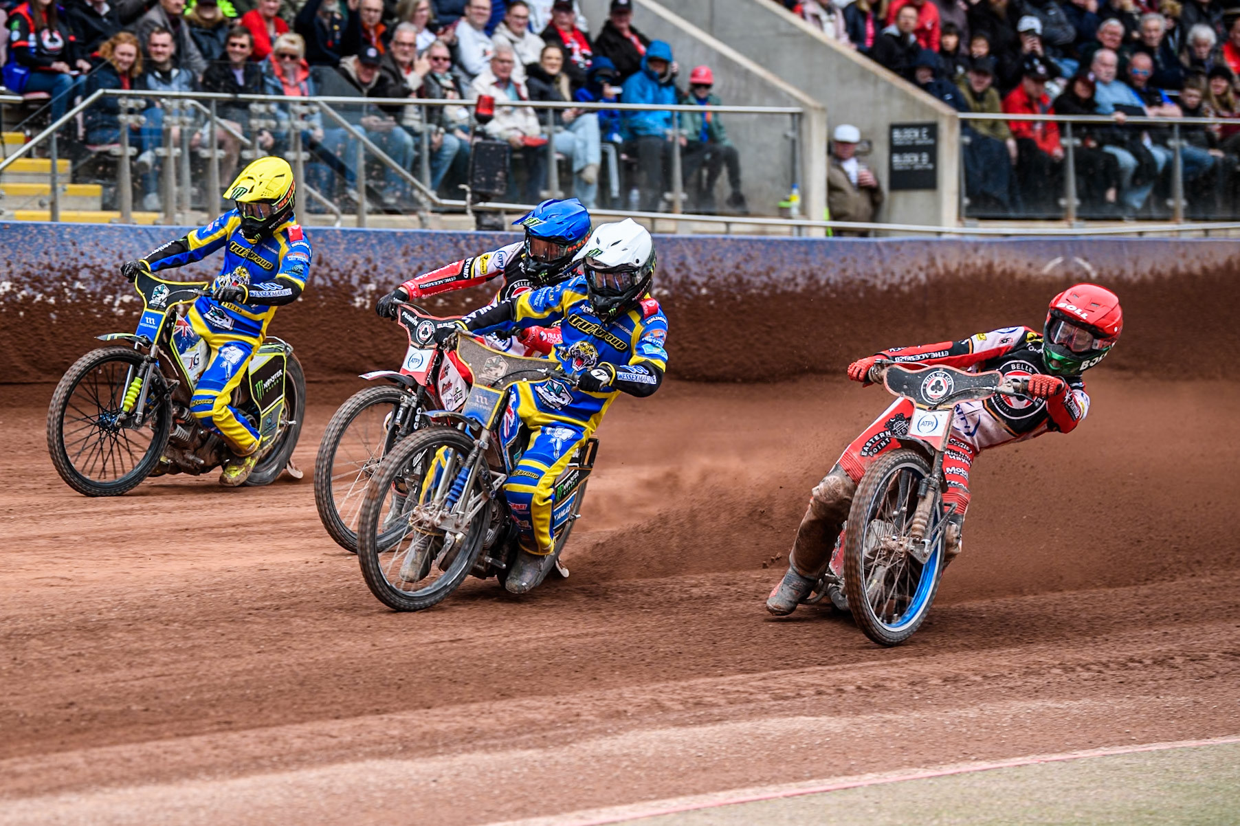 Brady Kurtz of Belle Vue Aces in Red rides inside Jack Holder of Sheffield Tigers in White, Dan Bewley of Belle Vue Aces in Blue and Chris Holder of Sheffield Tigers in Yellow during the Rowe Motor Oil Premiership match between Belle Vue Aces and Sheffield Tigers at the National Speedway Stadium, Manchester on Monday 5th May 2025. (Photo: Ian Charles | MI News)