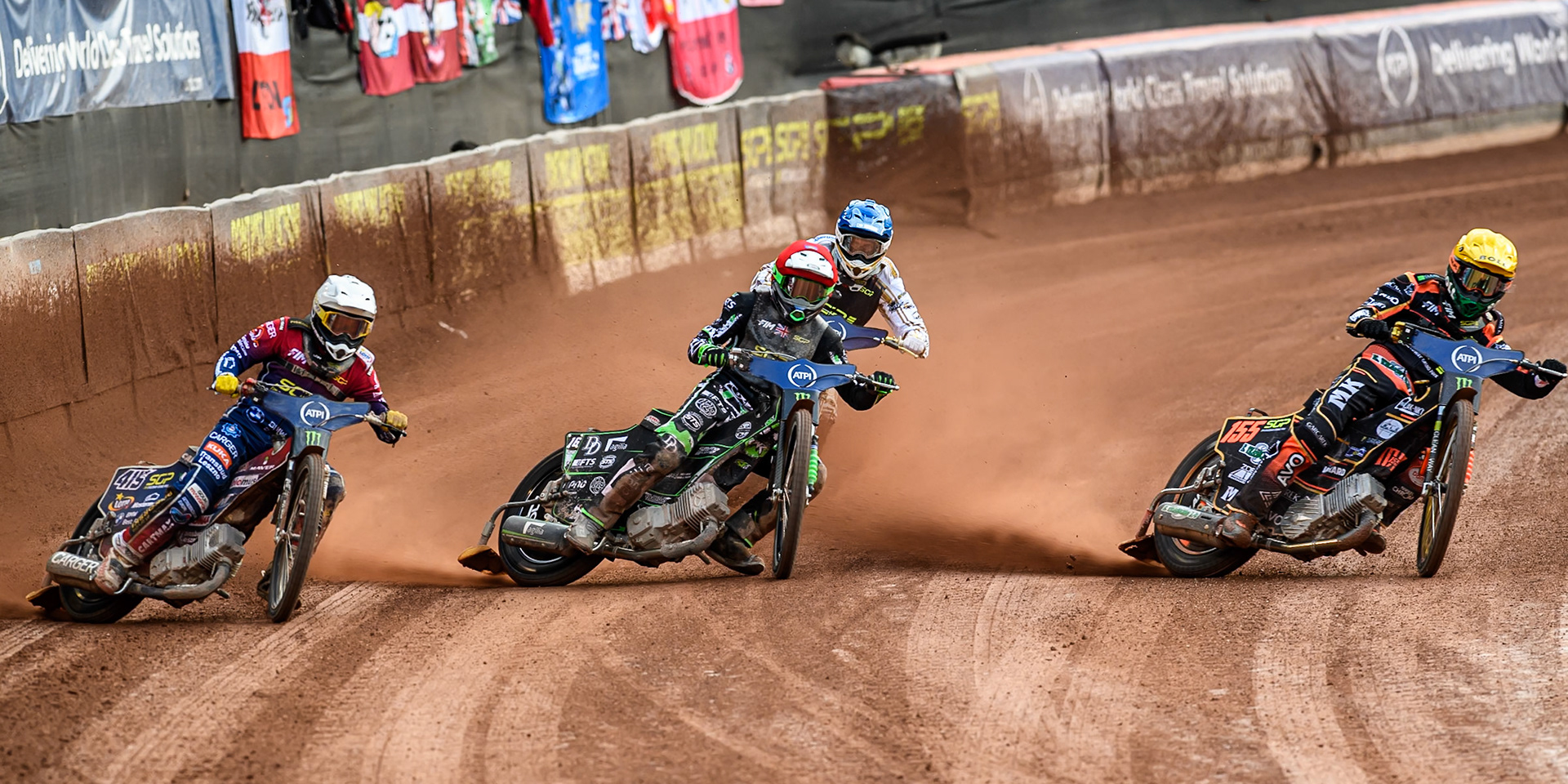 Mikkel Michelsen (155) of Denmark in Yellow rides inside Wild Card Charles Wright (16) of Great Britain in Red and Dominik Kubera (415) of Poland in White with Anders Thomsen (105) of Denmark in Blue behind during the ATPI FIM Speedway Grand Prix Round 4 at the National Speedway Stadium, Manchester, on Friday 13th June 2025. (Photo: Ian Charles | MI News)