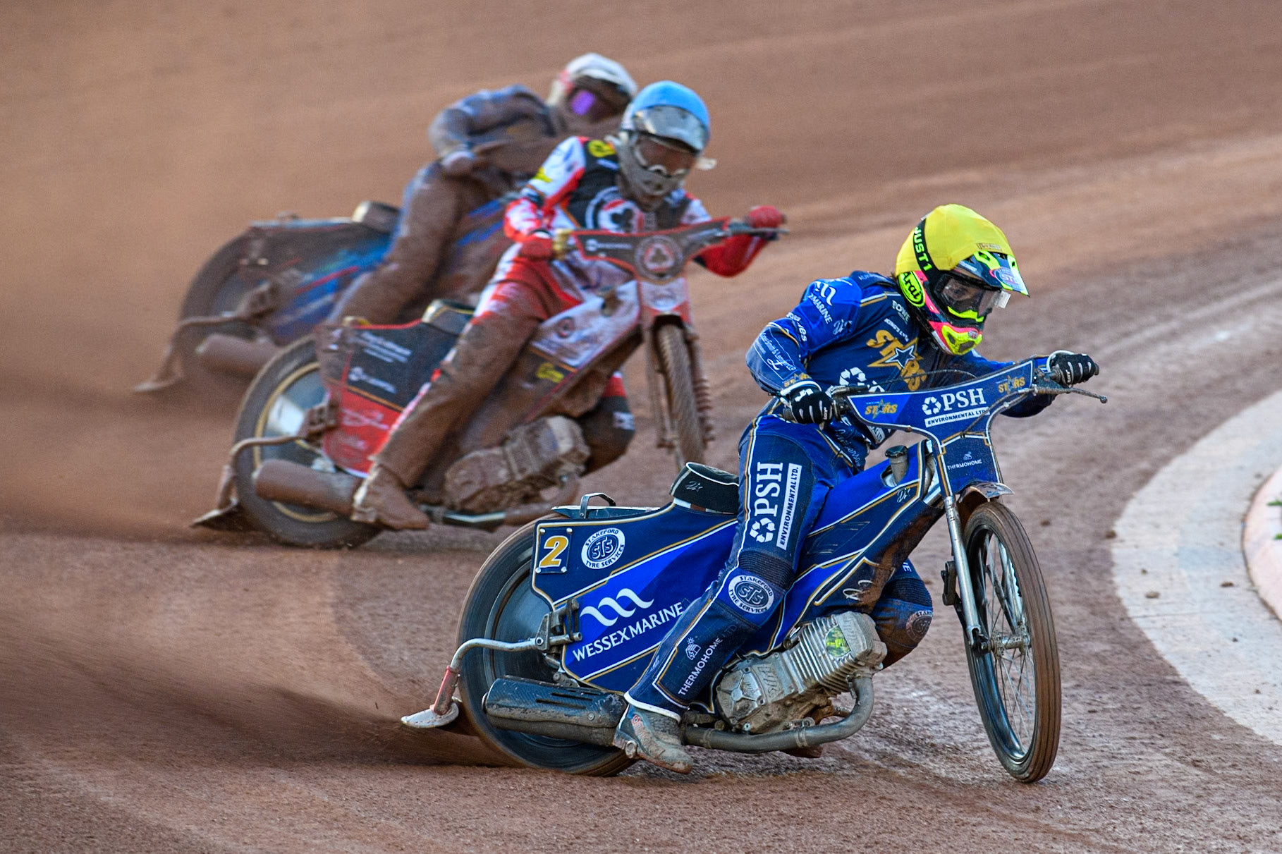Richard Lawson of Kings Lynn Stars in Yellow leading Norick Blödorn of Belle Vue Aces in Blue and Ben Cook of Kings Lynn Stars in White during the Rowe Motor Oil Premiership match between Belle Vue Aces and King's Lynn Stars at the National Speedway Stadium, Manchester on Monday 5th April 2025. (Photo: Ian Charles | MI News)