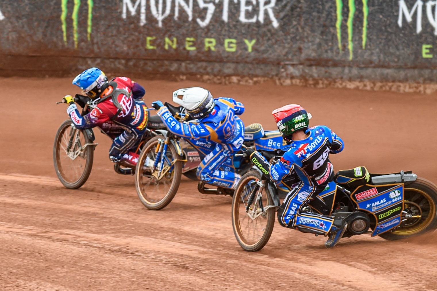 Jason Doyle (69) of Australia in Red chases Bartosz Zmarzlik (95) of Poland in White and Dominik Kubera (415) of Poland in Blue during the ATPI FIM Speedway Grand Prix Round 4 at the National Speedway Stadium, Manchester, on Friday 13th June 2025. (Photo: Ian Charles | MI News)