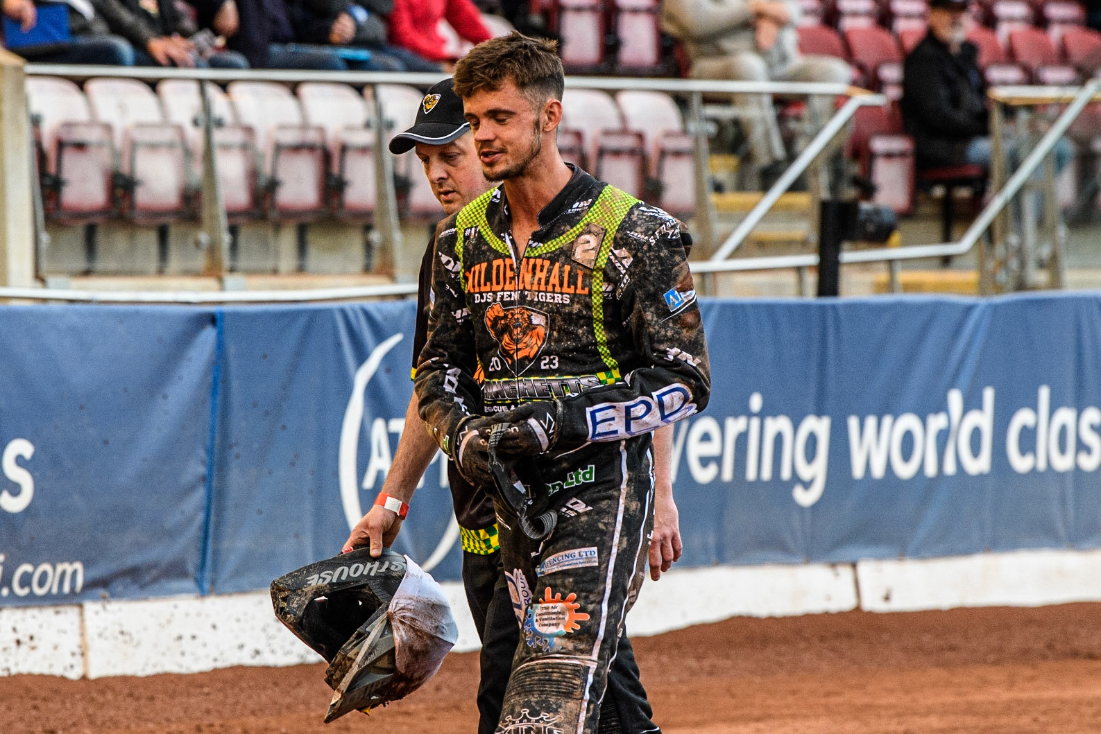 Josh Warren walks back to the pits after his fall with Mildenhall Manchettes Fen Tigers team manager Jason Gardner (partially hidden) during the National Development League match between Belle Vue Colts and Mildenhall Fens Tigers at the National Speedway Stadium, Manchester on Friday 26th May 2023. (Photo: Ian Charles | MI News)