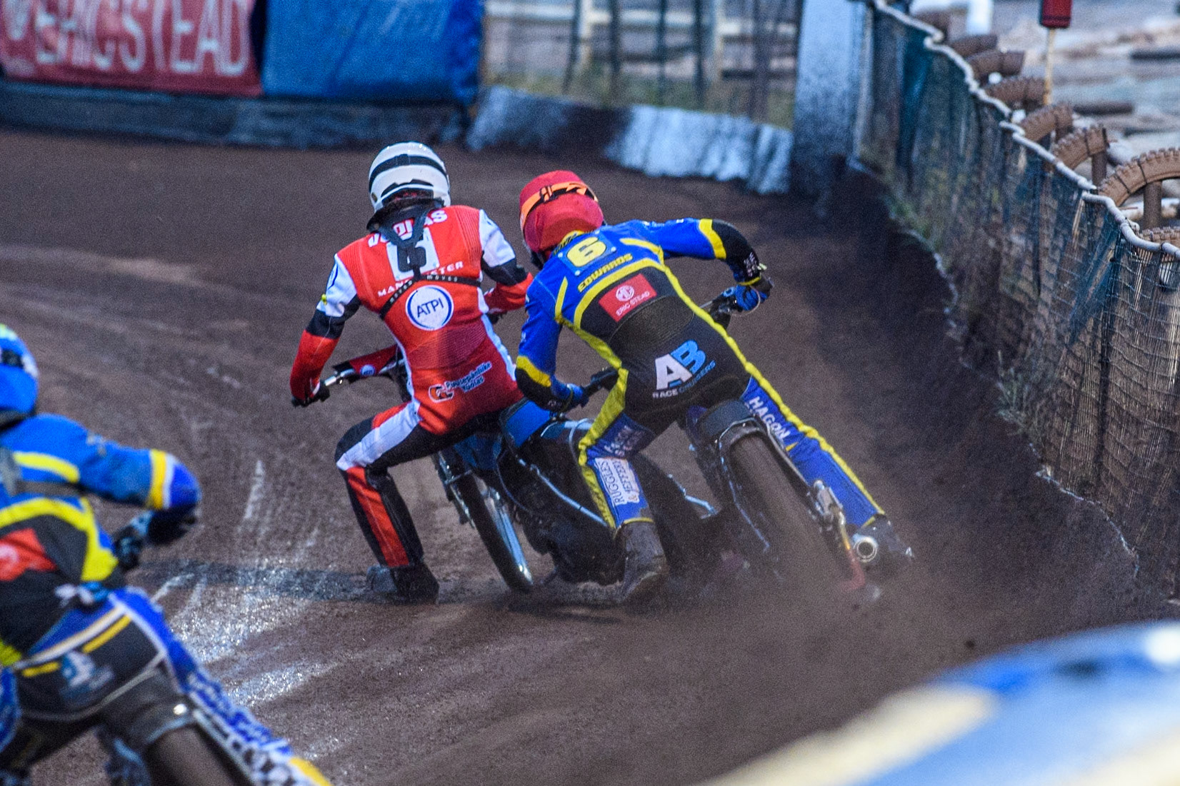 Sheffield Tigers' Jason Edwards  in Red catches his leg on the rear tyre of Belle Vue Aces' Antti Vuolas in White during the Rowe Motor Oil Premiership match between Sheffield Tigers and Belle Vue Aces at Owlerton Stadium, Sheffield on Monday 26th August 2024. (Photo: Ian Charles | MI News)