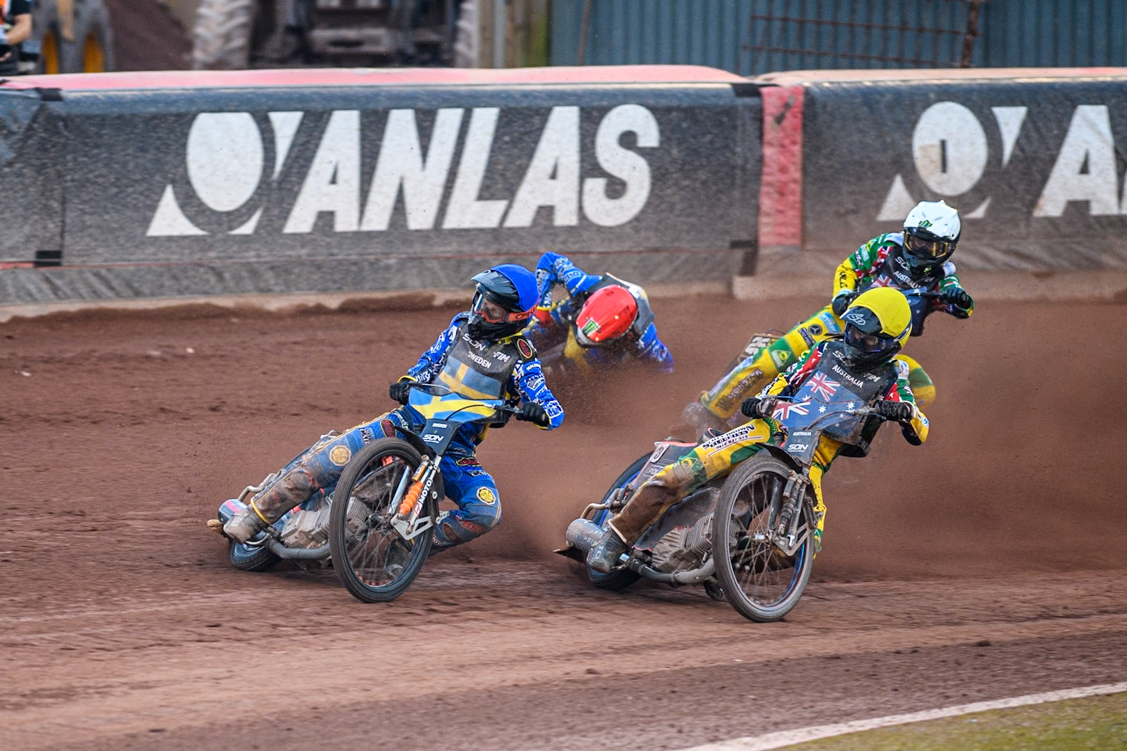 SWEDEN v AUSTRALIA: Jacob Thorssell of Sweden in Blue leading Brady Kurtz of Australia in Yellow and Jack Holder of Australia in White as Fredrik Lindgren of Sweden in Red slides off in the dirt during the Monster Energy FIM Speedway of Nation Final at the National Speedway Stadium, Manchester on Saturday 13th July 2024. (Photo: Ian Charles | MI News)