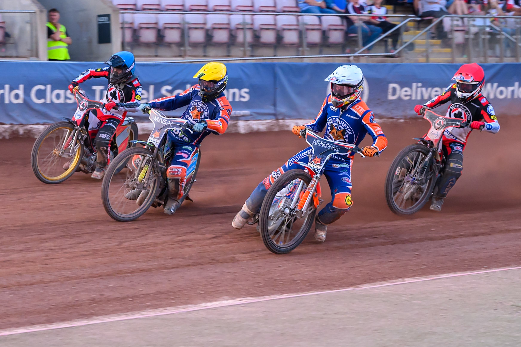 Nicolai Klindt of Northampton Foxes in White rides inside Jaimon Lidsey of Northampton Foxes  in Yellow  and Norick Blodorn of Belle Vue Aces  in Blue  with Zach Cook of Belle Vue Aces in Red  behind during the Rowe Motor Oil Premiership match between Belle Vue Aces and Northampton Foxes at the National Speedway Stadium, Manchester on Monday 13th July 2026. (Photo: Ian Charles | MI News)